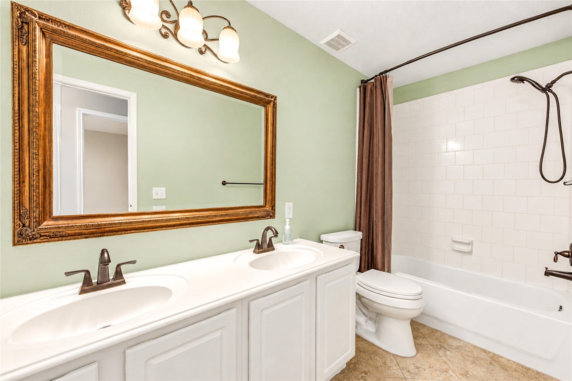 Secondary bathroom offers double sinks and tub/shower combo.
