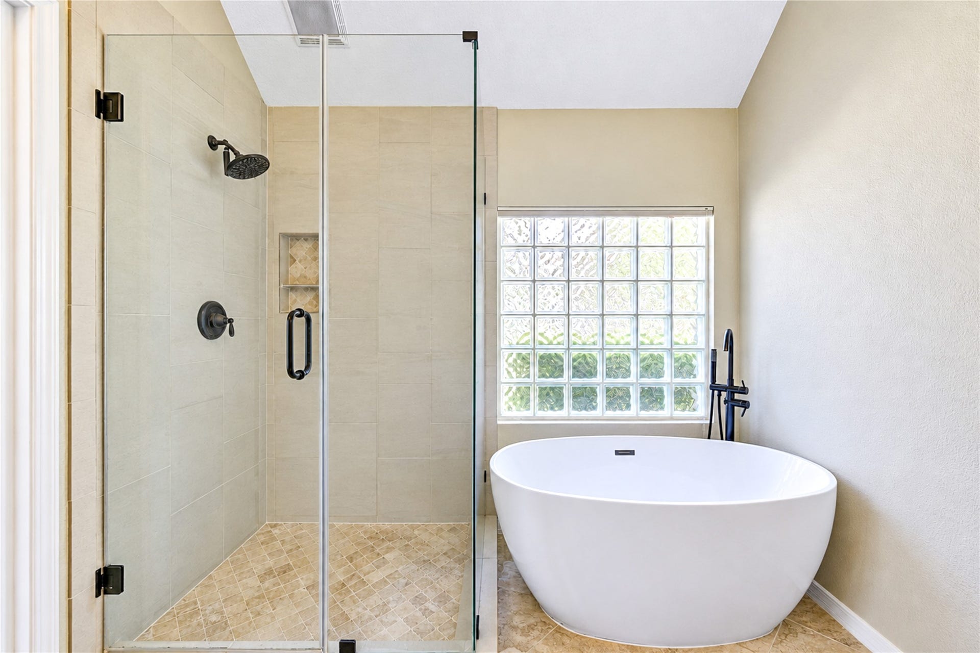 Primary bathroom offers a relaxing soaker tub and separate shower.