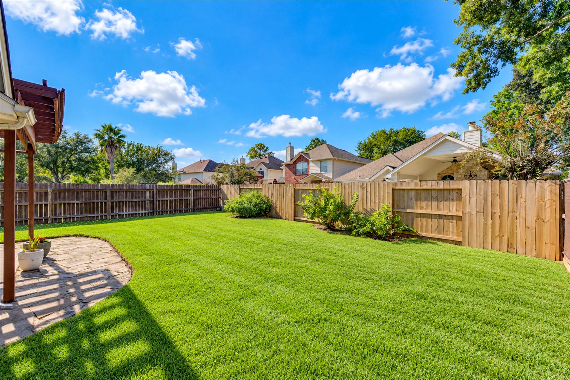 Fence recently replaced, the backyard is ready for gatherings.