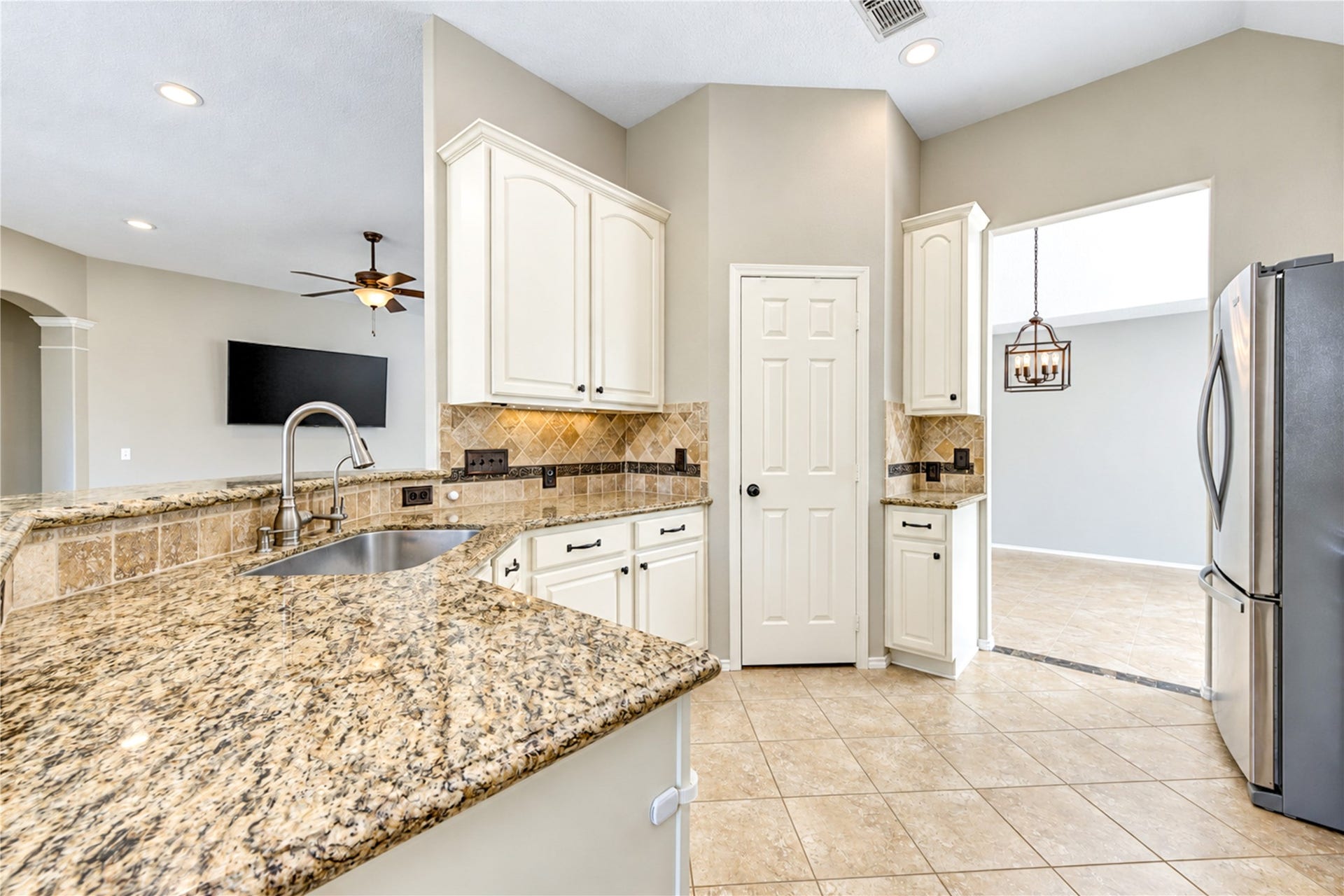 Beautiful white cabinetry, stainless steel appliances, and granite countertops create a bright, functional kitchen designed to suit any lifestyle.