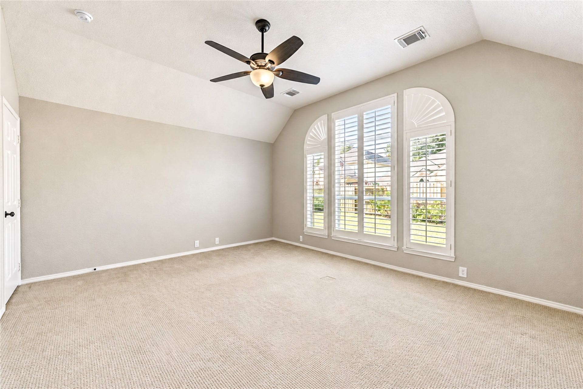Large primary window with plantation shutters