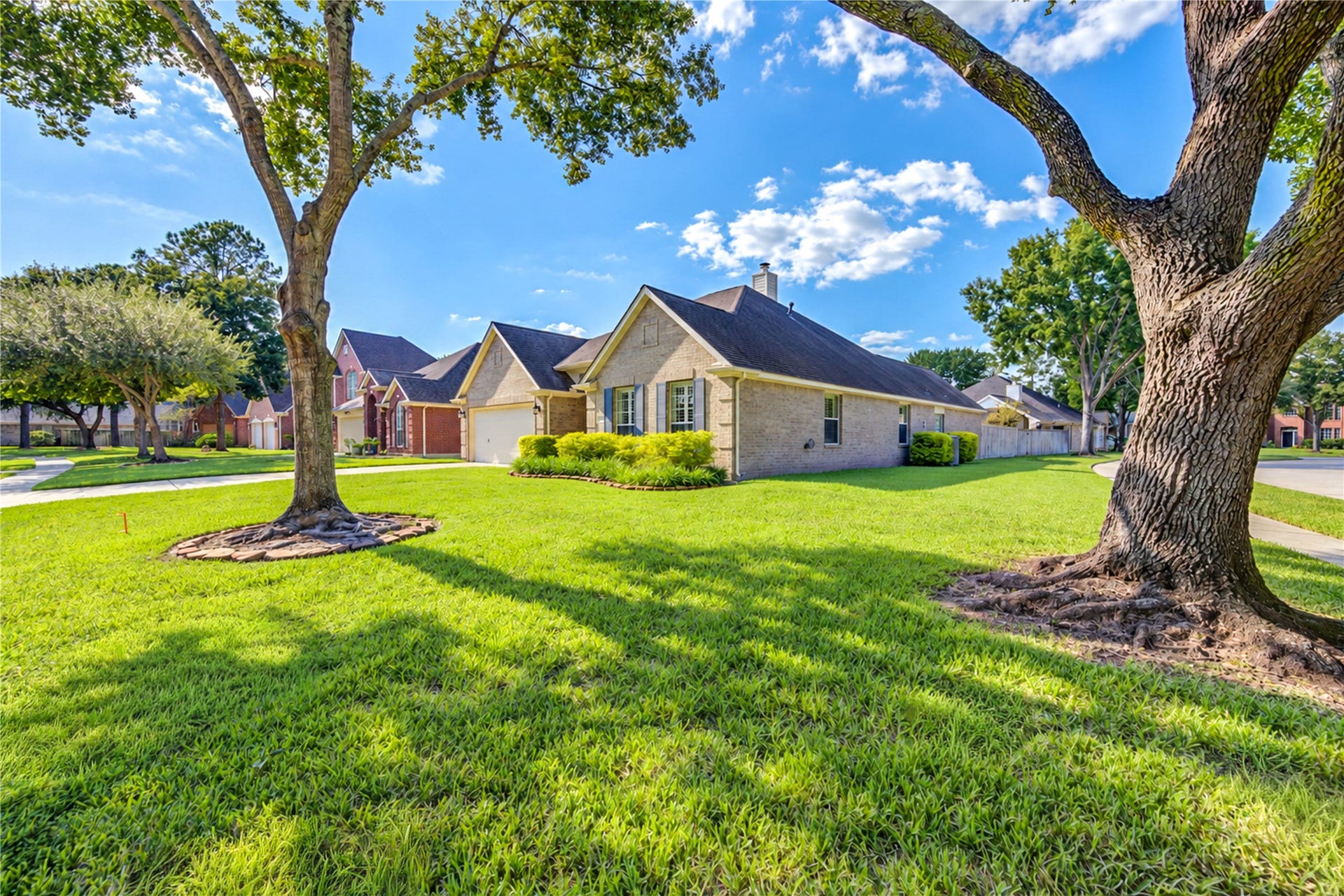 Beautifully maintained brick home situated on a spacious corner lot with mature trees and lush landscaping offering A+ curb appeal.