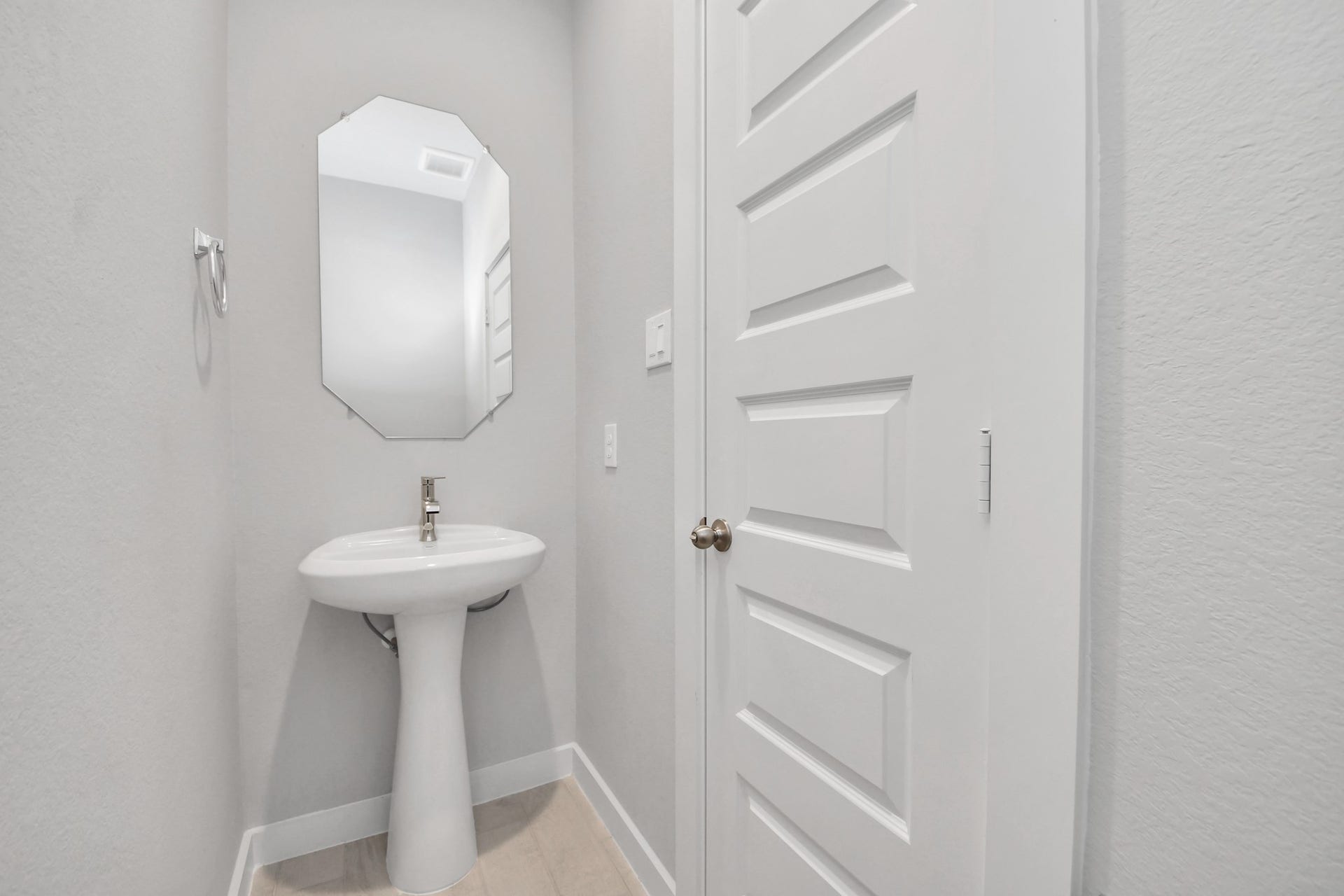 5826 Madison Trail Drive, Richmond, TX 77469 This half bathroom features a stylish pedestal sink, modern hardware, and bright recessed lighting, creating a sleek and inviting space. Sample photo of completed home with similar floor plan. Actual colors and selections may vary.