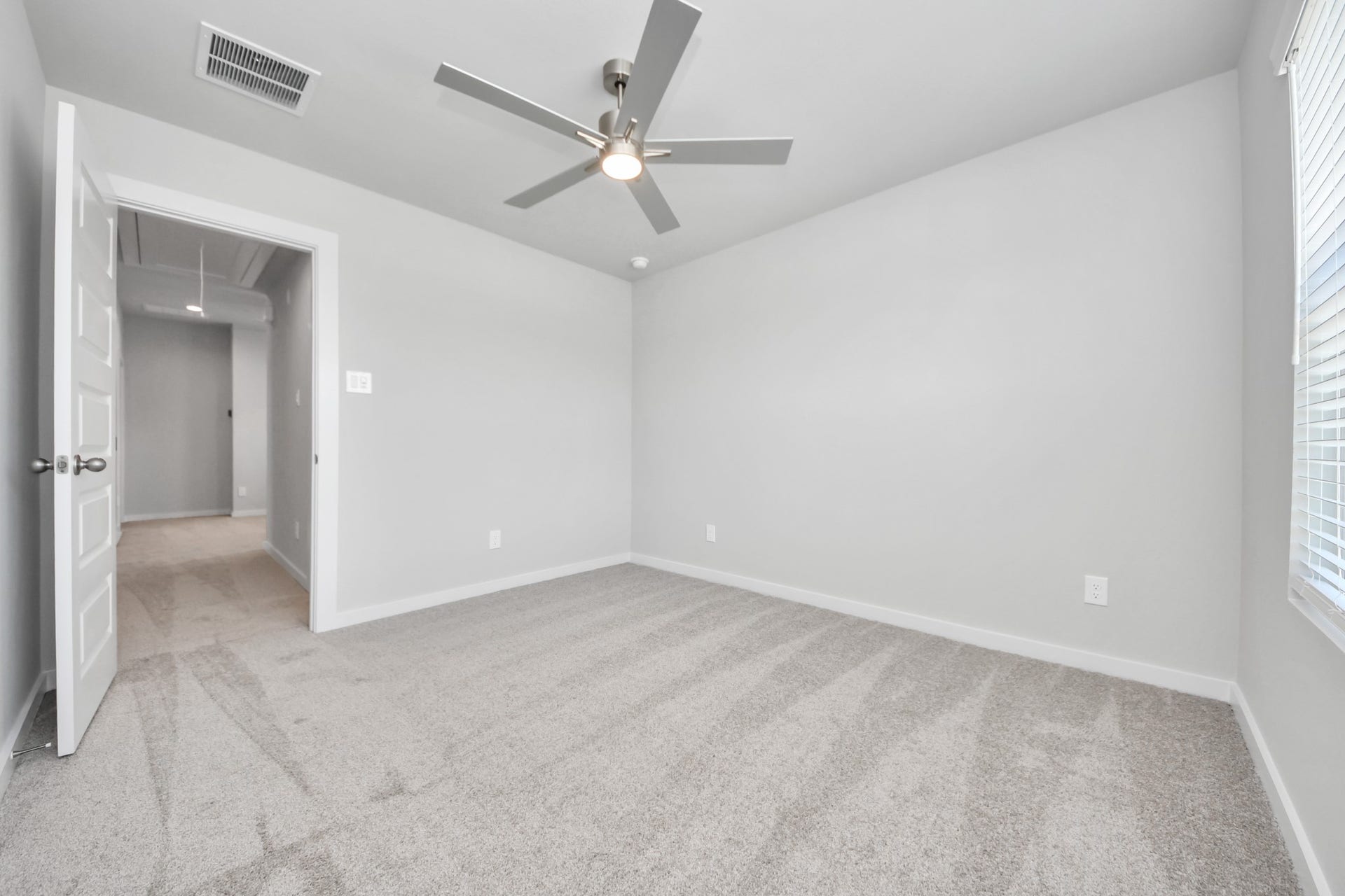 5826 Madison Trail Drive, Richmond, TX 77469 Generously sized secondary bedrooms featuring spacious closets, soft and inviting carpeting underfoot, large windows allowing plenty of natural light, and the added touch of privacy blinds for your personal retreat. Sample photo of completed home with similar floor plan. Actual colors and selections may vary.