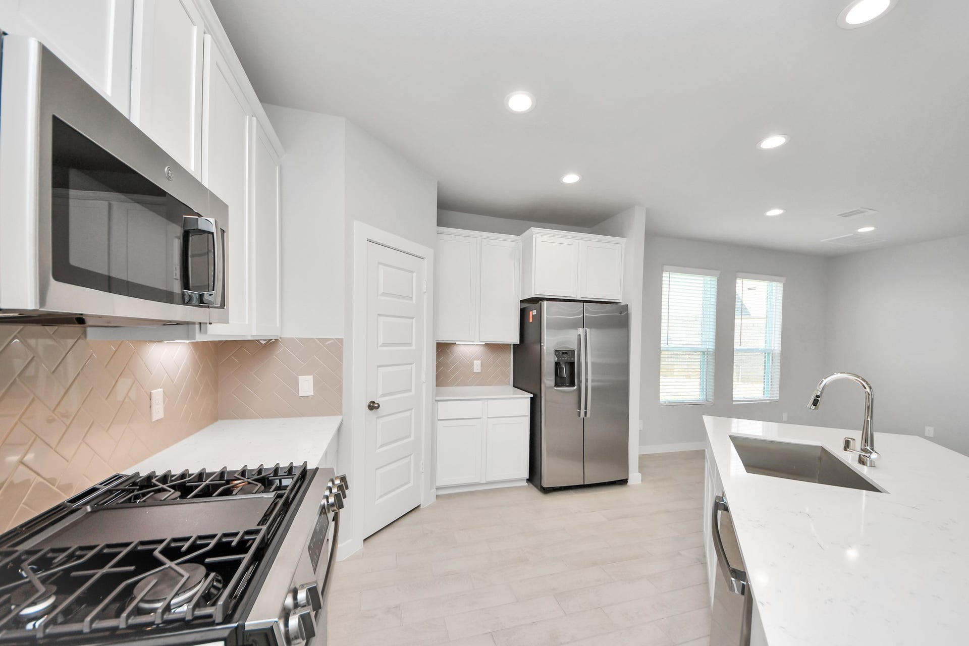 5826 Madison Trail Drive, Richmond, TX 77469 Discover another perspective of this stunning kitchen, generously appointed with an abundance of counter space. Sample photo of completed home with similar floor plan. Actual colors and selections may vary.