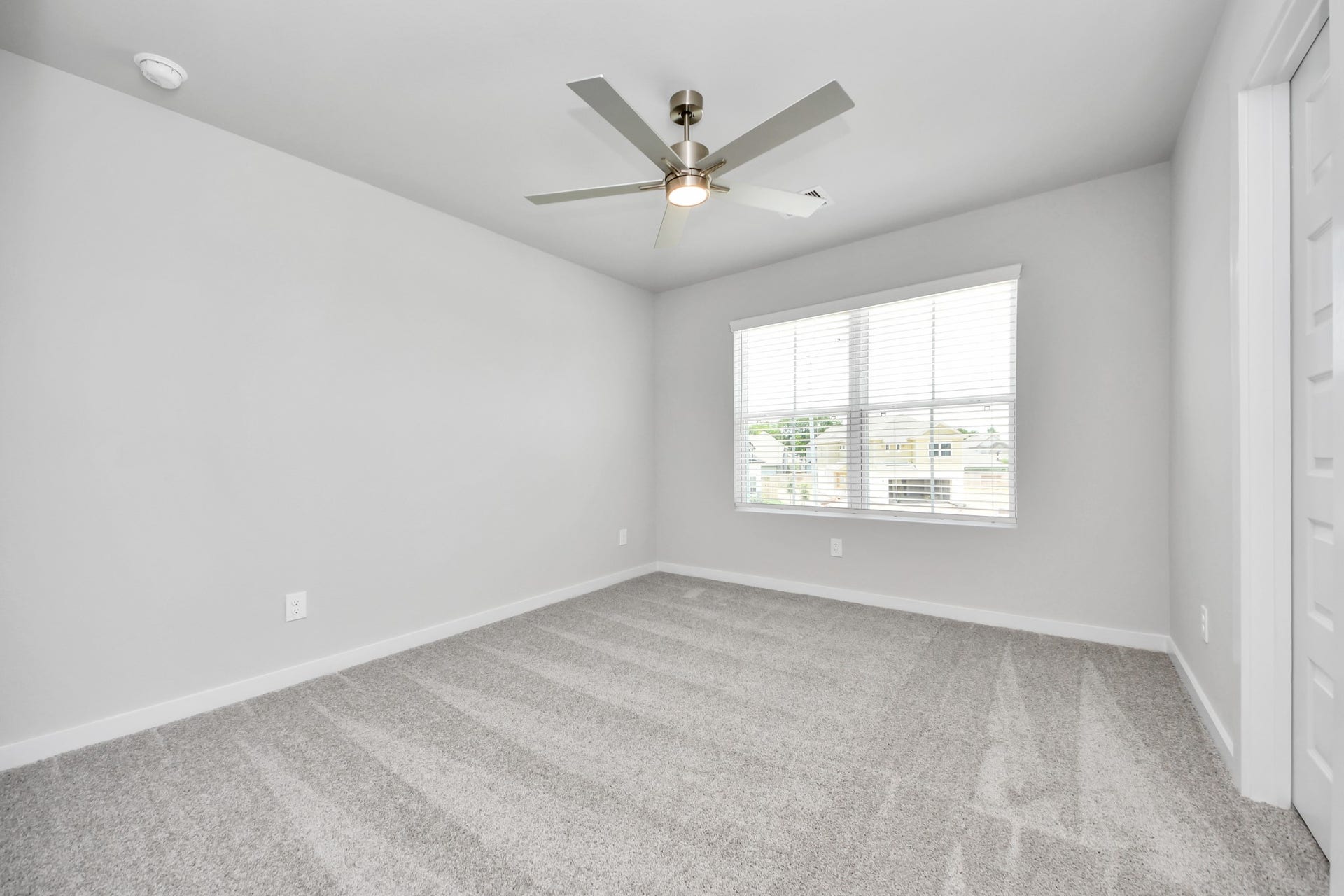 5826 Madison Trail Drive, Richmond, TX 77469 Secondary bedroom features plush carpeting, large windows that let in plenty of natural light, bright paint, and spacious closets. Sample photo of completed home with similar floor plan. Actual colors and selections may vary.