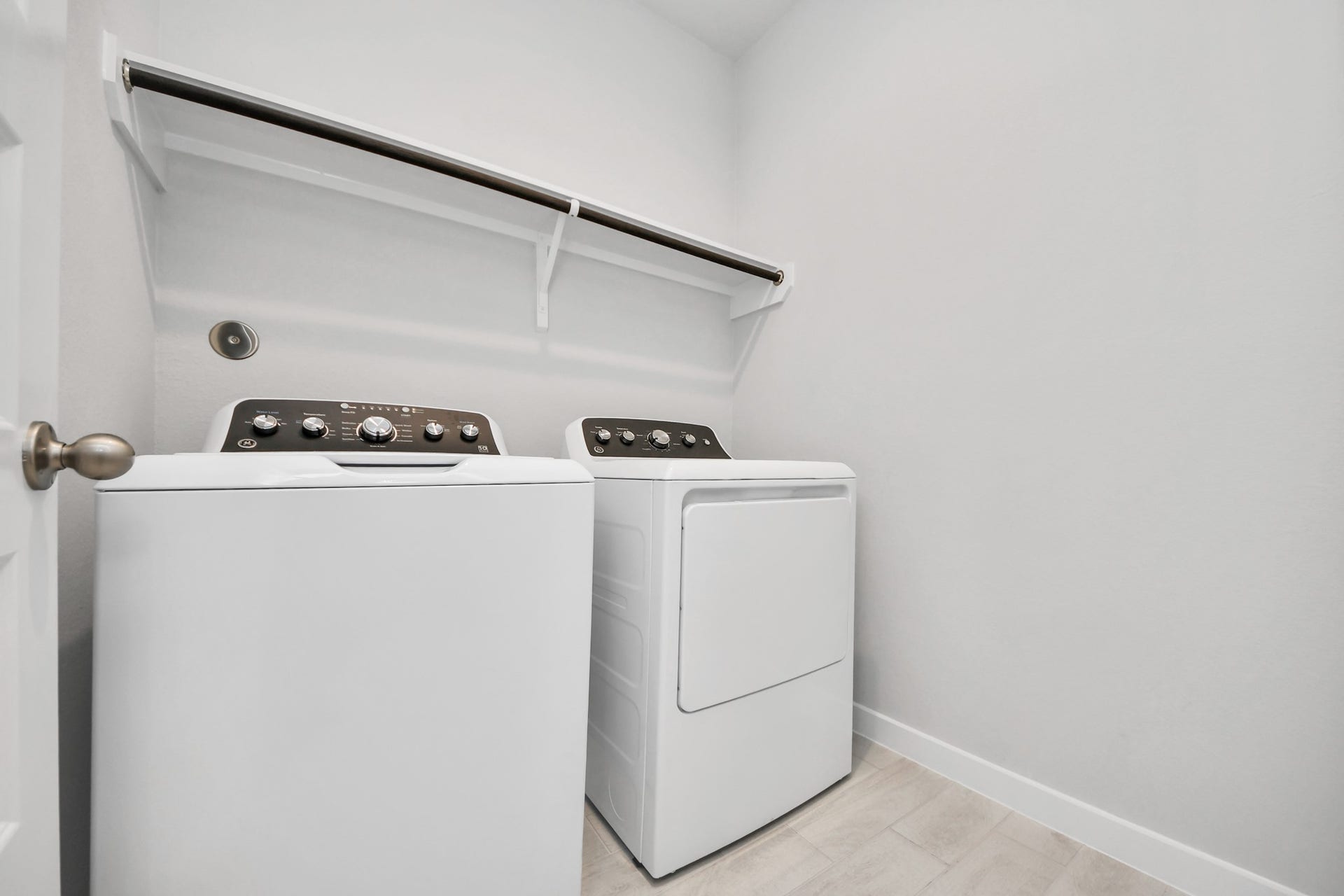 5826 Madison Trail Drive, Richmond, TX 77469 A perfect blend of functionality and comfort. Capture the essence of easy living with a first-floor laundry room, thoughtfully equipped with shelving for effortless organization. Both electric and gas connections available. Sample photo of completed home with similar floor plan. Actual colors and selections may vary.