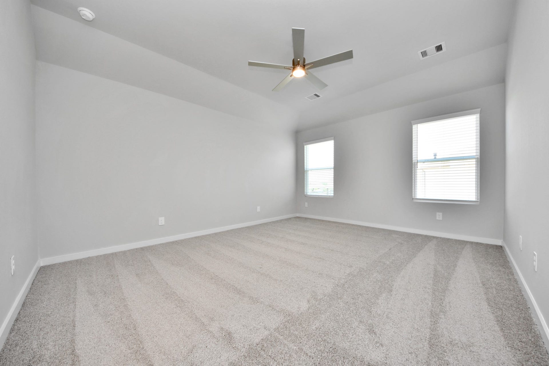 5826 Madison Trail Drive, Richmond, TX 77469 Escape to tranquility in this spacious primary room, adorned with plush carpeting and bathed in the soothing hues of warm paint colors, creating a cozy retreat for relaxation. Sample photo of completed home with similar floor plan. Actual colors and selections may vary.