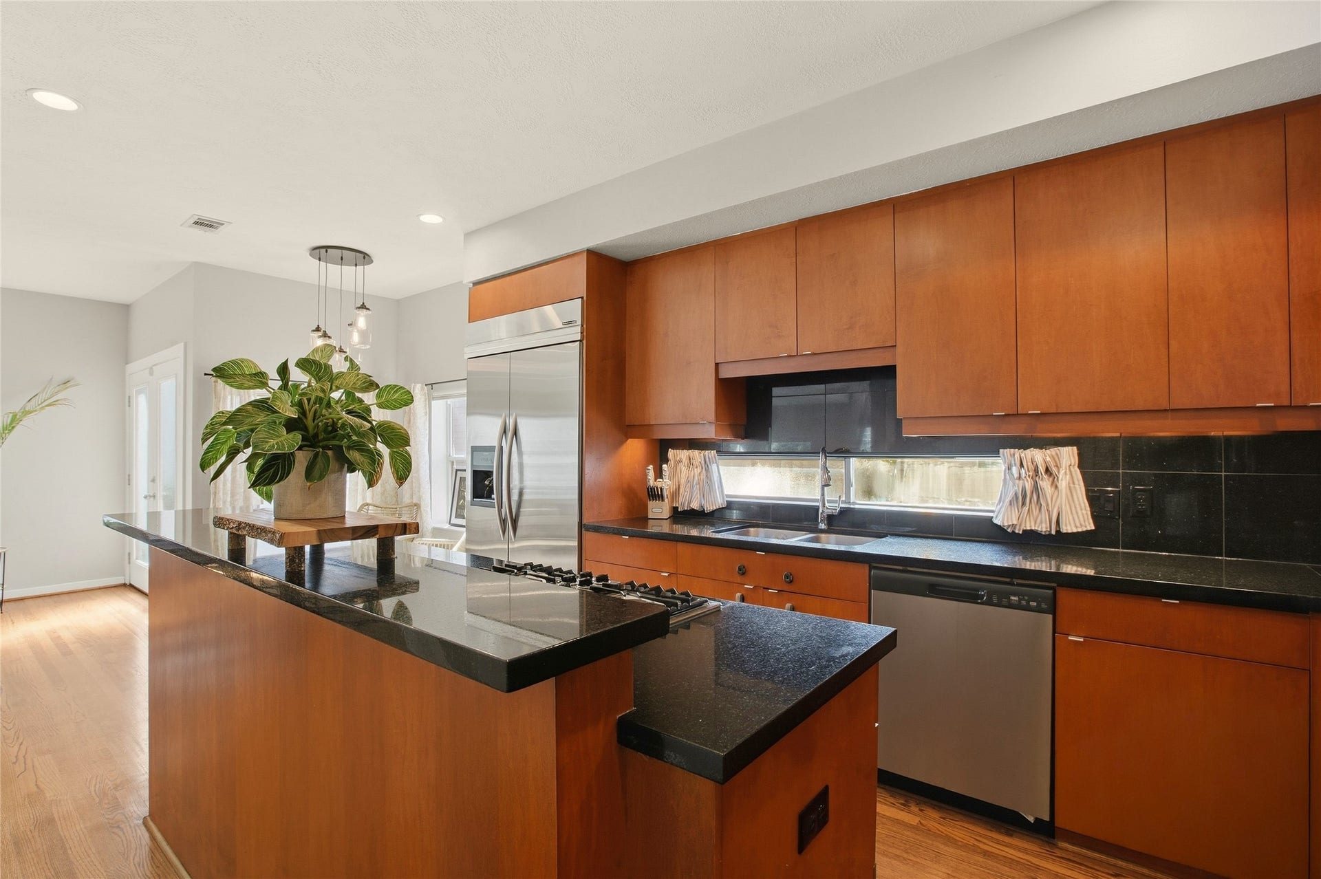 1803 Oneil Street, #C, Houston, TX 77019 Gas cooktop island, granite counters and a window backsplash for natural light.