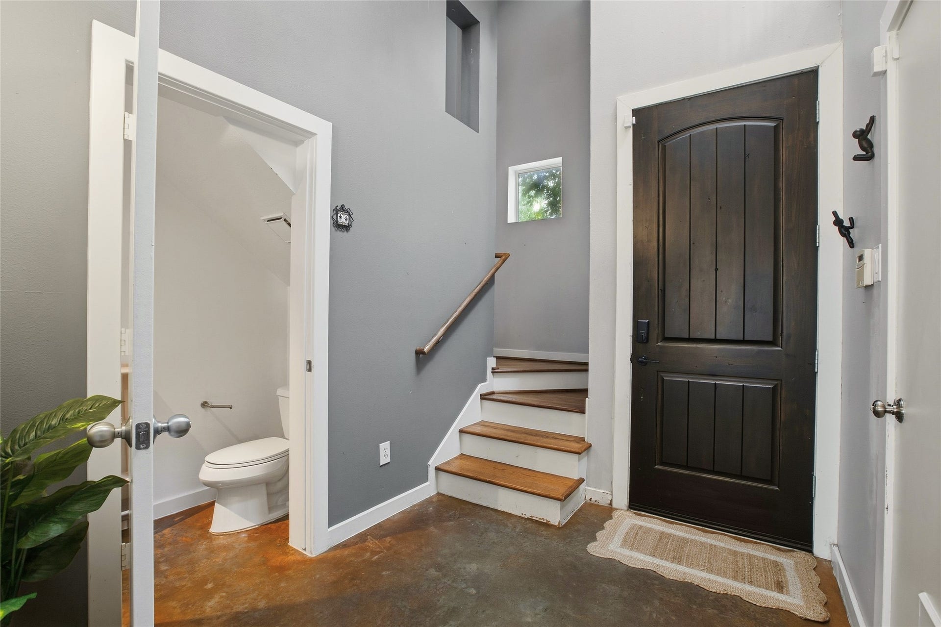 1803 Oneil Street, #C, Houston, TX 77019 Stylish foyer with a custom wood front door and an open staircase.