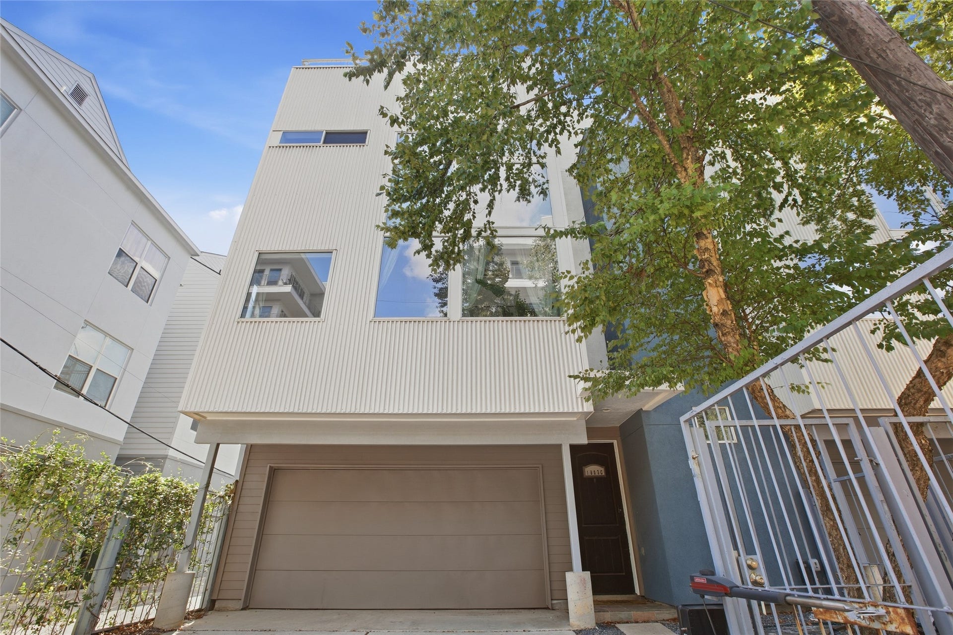 1803 Oneil Street, #C, Houston, TX 77019 Striking modern facade with oversized windows and mature shade trees.