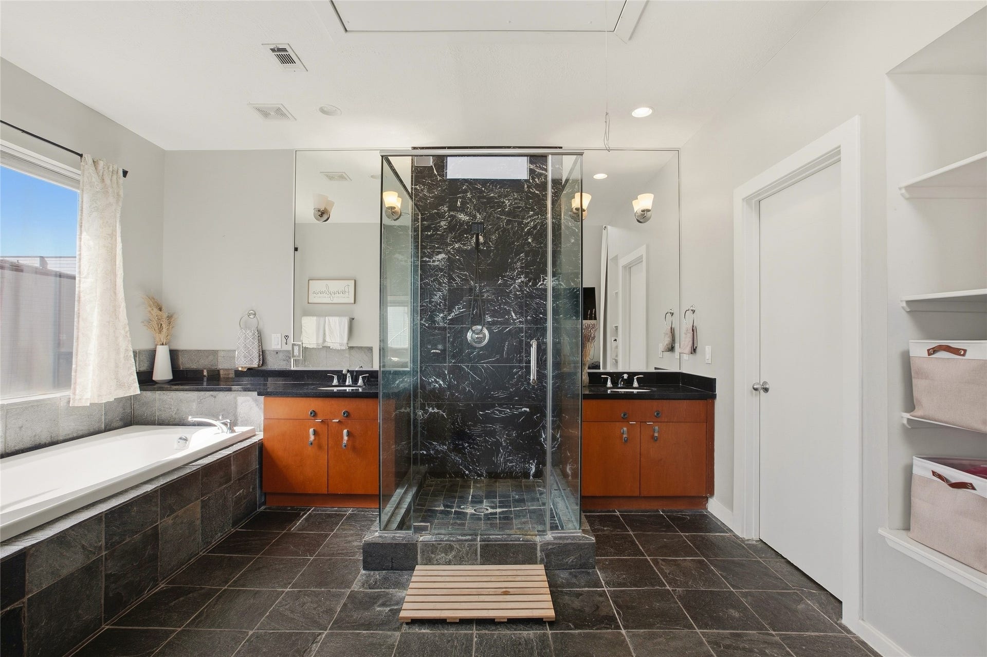 1803 Oneil Street, #C, Houston, TX 77019 Primary bath with dual vanities, a soaking tub & a frameless marble shower.