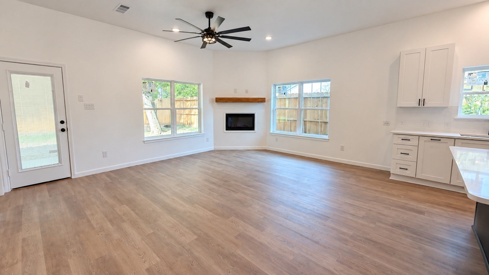 8715 Victoria Forest Drive, Houston, TX 77088 Modern electric fireplace featuring a stylish wood accent wall for a warm and contemporary look.