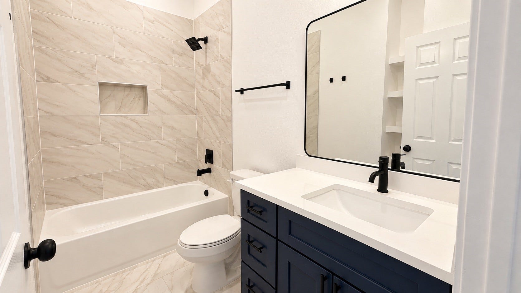 8715 Victoria Forest Drive, Houston, TX 77088 Modern guest bathroom featuring a beautiful color palette and elegant lighting fixtures.