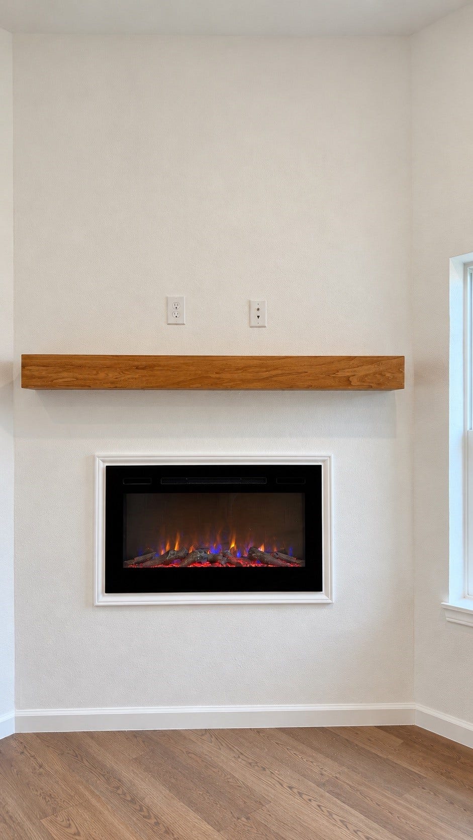 8715 Victoria Forest Drive, Houston, TX 77088 Modern electric fireplace featuring a stylish wood accent wall for a warm and contemporary look.