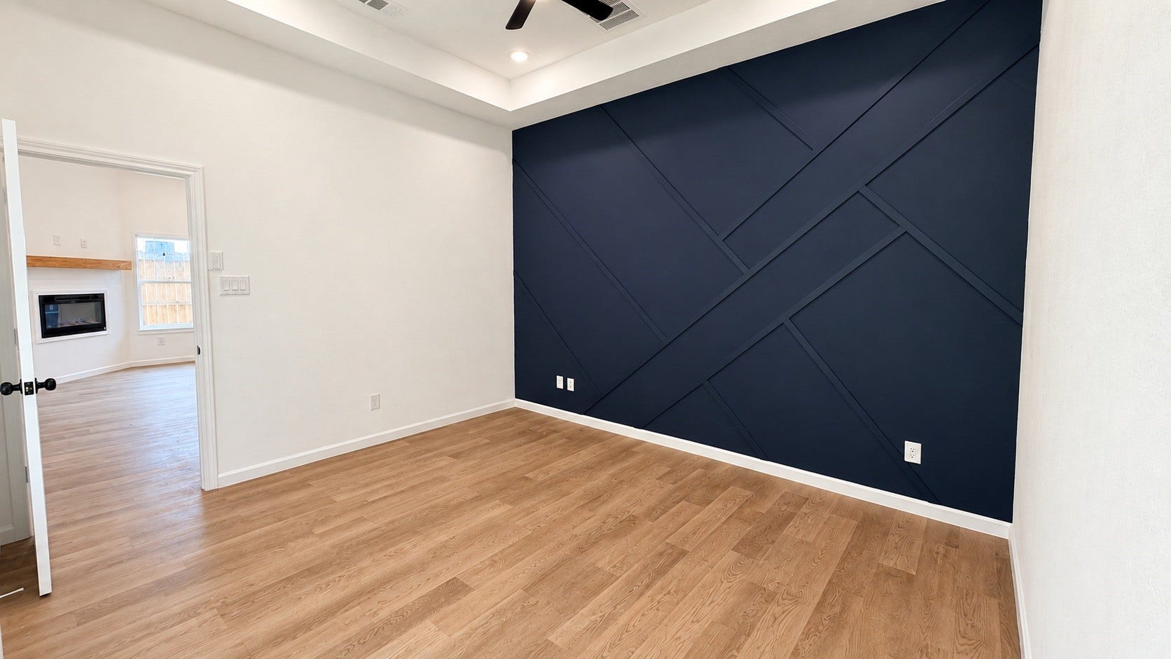 8715 Victoria Forest Drive, Houston, TX 77088 Bright primary bedroom featuring custom accent wall & durable vinly plank flooring