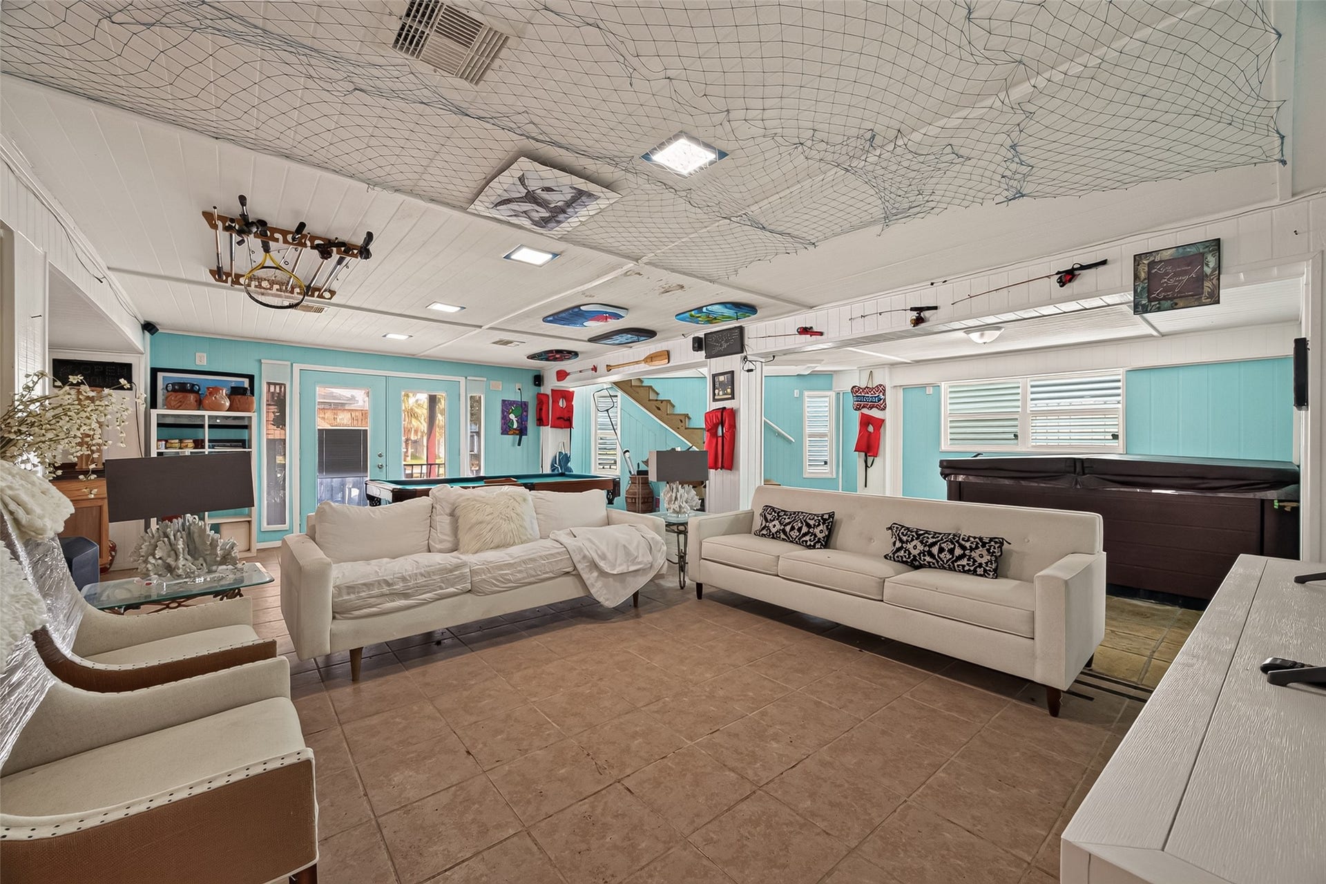 The ultimate party zonea sprawling coastal-themed social lounge equipped with a full-sized pool table, relaxing hot tub, and boundless room for entertaining.