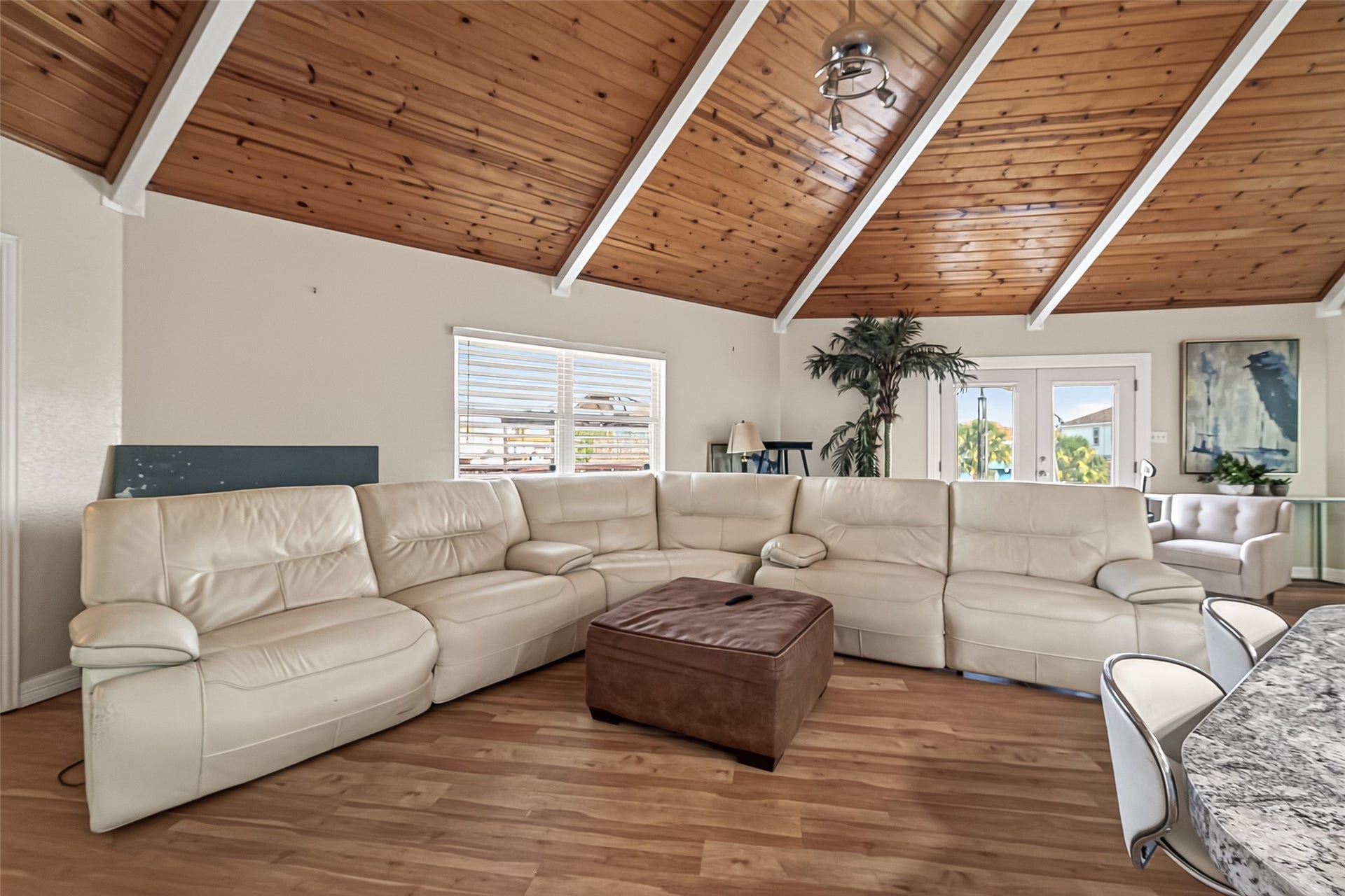 Effortless indoor-outdoor synergyglass-paneled double doors open wide to connect the indoor salon directly with the expansive upper sky deck.