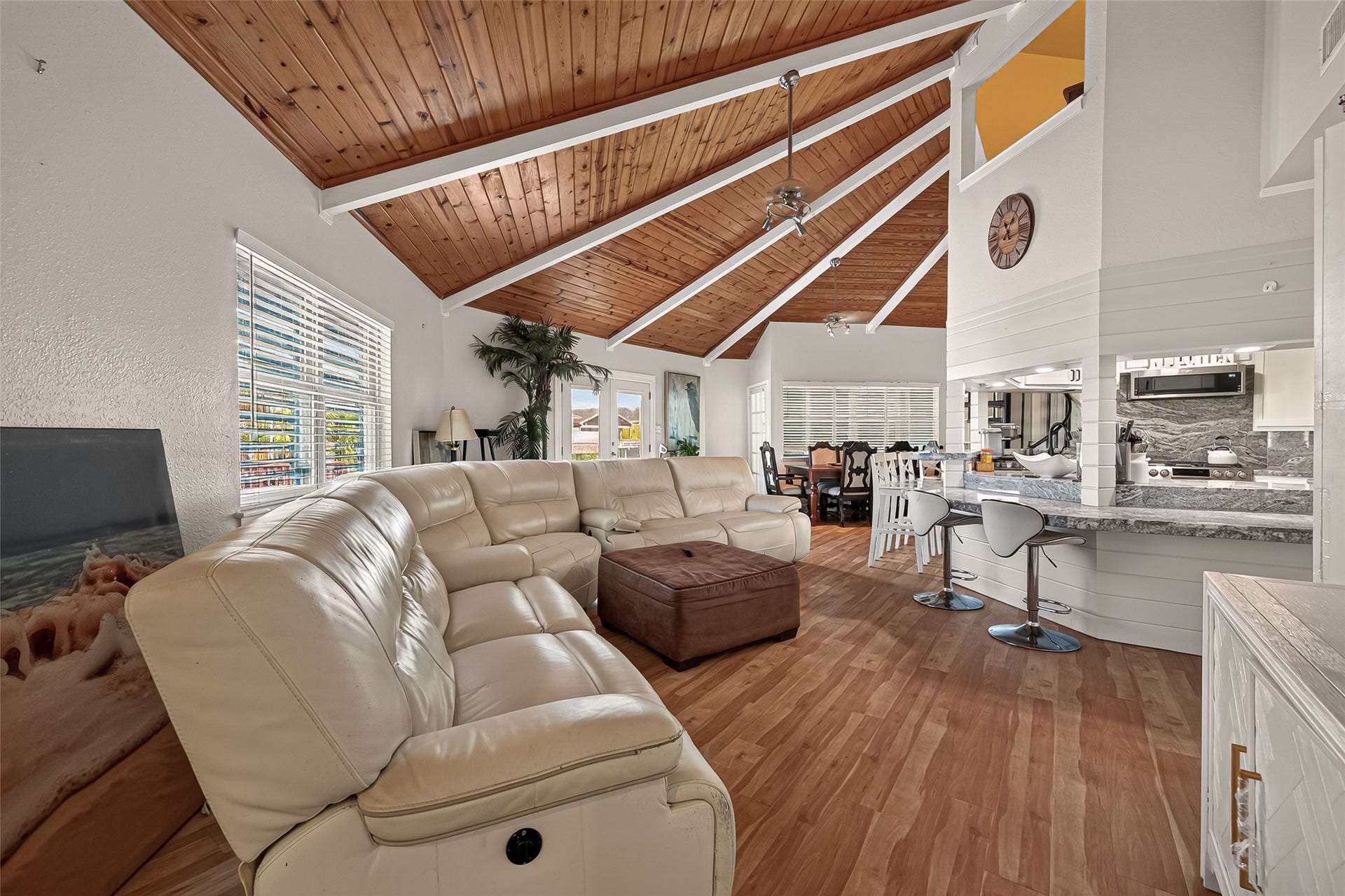 An architectural marvel featuring a dramatic multi-angled layout where a central kitchen, fluid seating, and dining areas harmoniously converge.