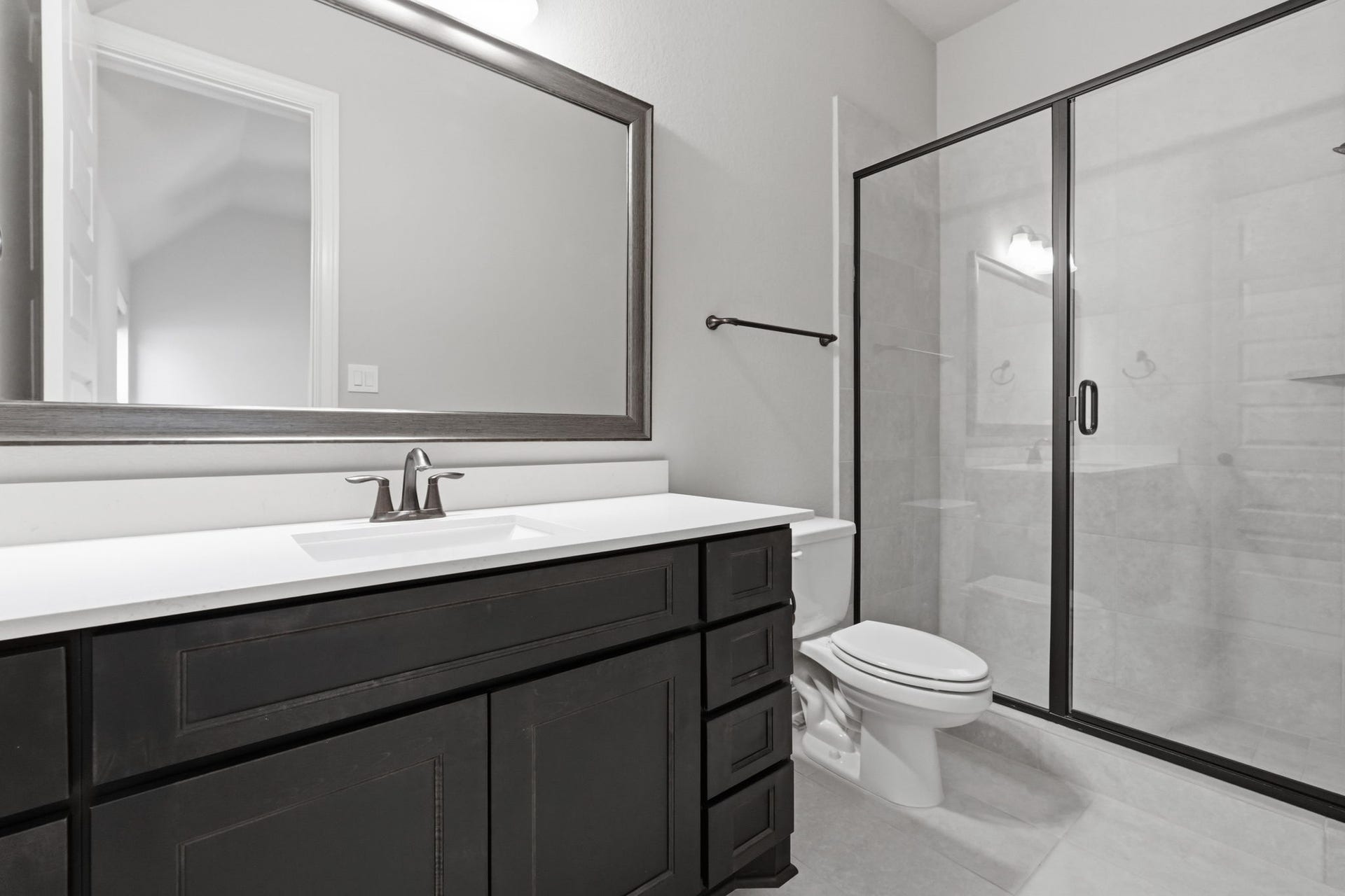 15223 Prairie Dog Town Lane, Cypress, TX 77433 Bright secondary bath featuring a sleek vanity, contemporary fixtures, and a glass-enclosed shower accented by clean, modern finishes.