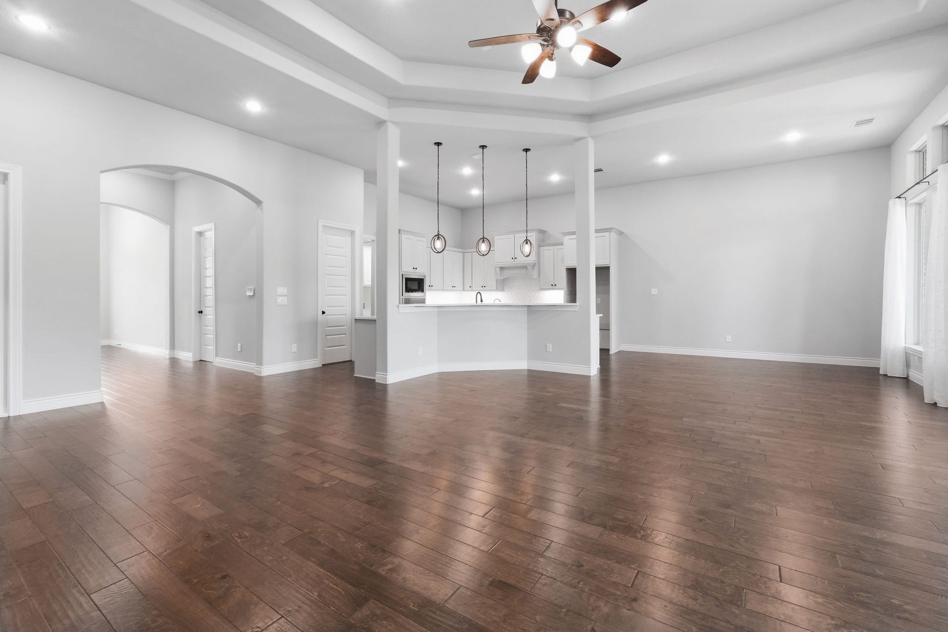15223 Prairie Dog Town Lane, Cypress, TX 77433 View from the living room toward the kitchen, showcasing the open-concept layout perfect for everyday living and entertaining.