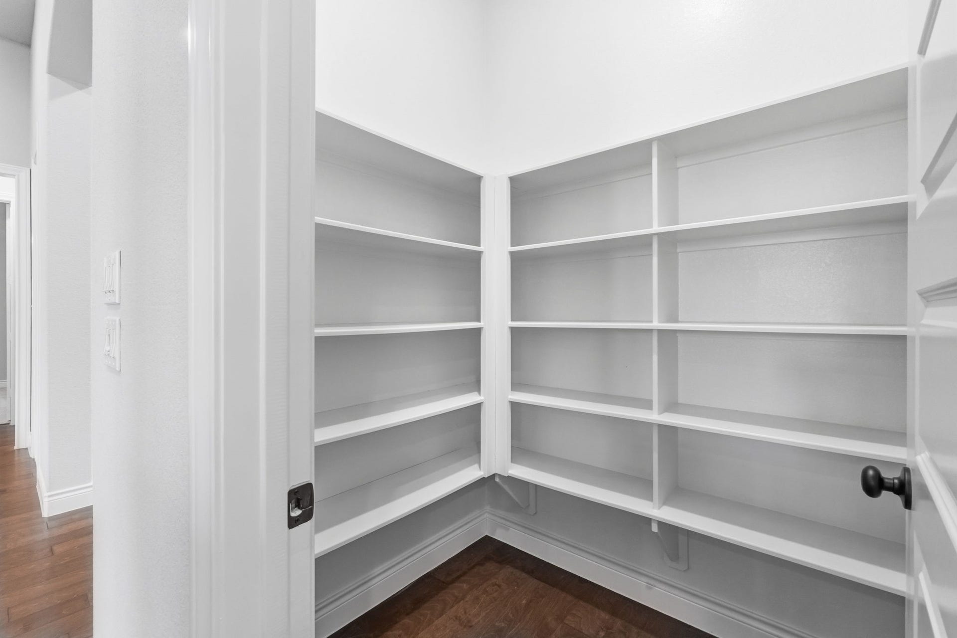 15223 Prairie Dog Town Lane, Cypress, TX 77433 A large walk-in pantry designed to keep everything within reach, with generous built-in shelving and room to neatly organize kitchen essentials.