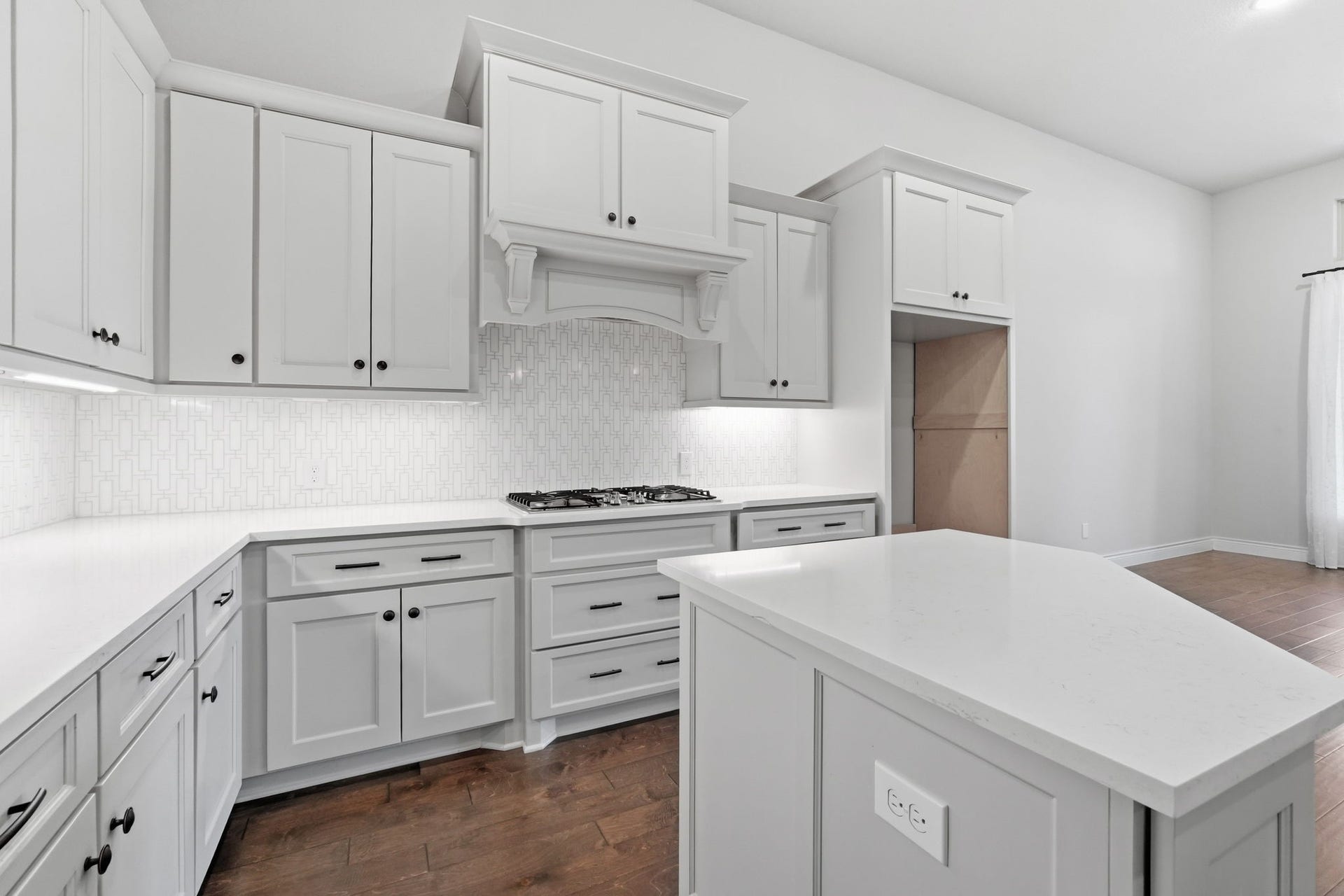 15223 Prairie Dog Town Lane, Cypress, TX 77433 Bright, well-appointed kitchen featuring white cabinetry, a spacious center island, and clean architectural lines.