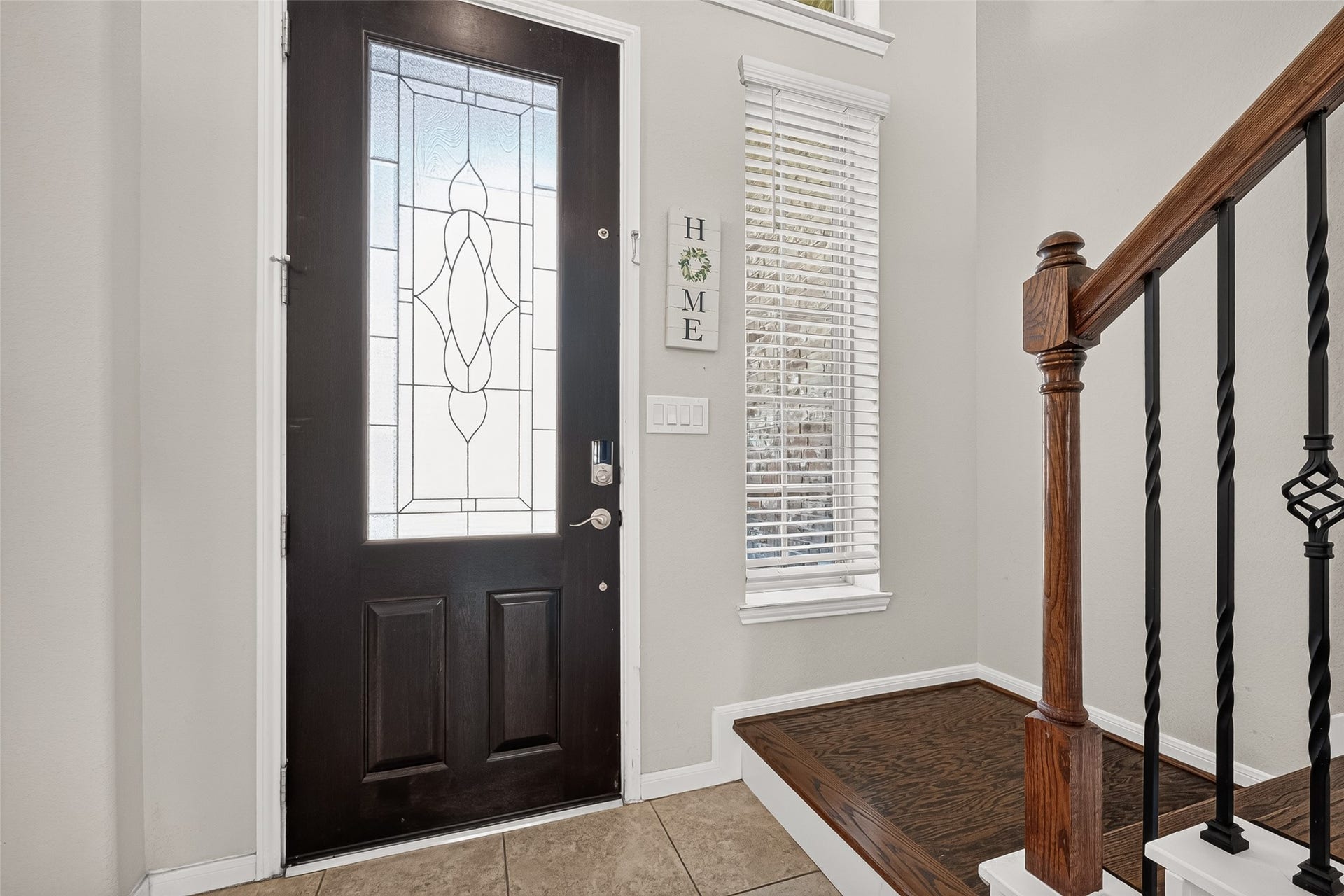 6111 Wayne Way, Rosenberg, TX 77471 Natural light brightens the entry, with tile flooring and a wood staircase just inside.