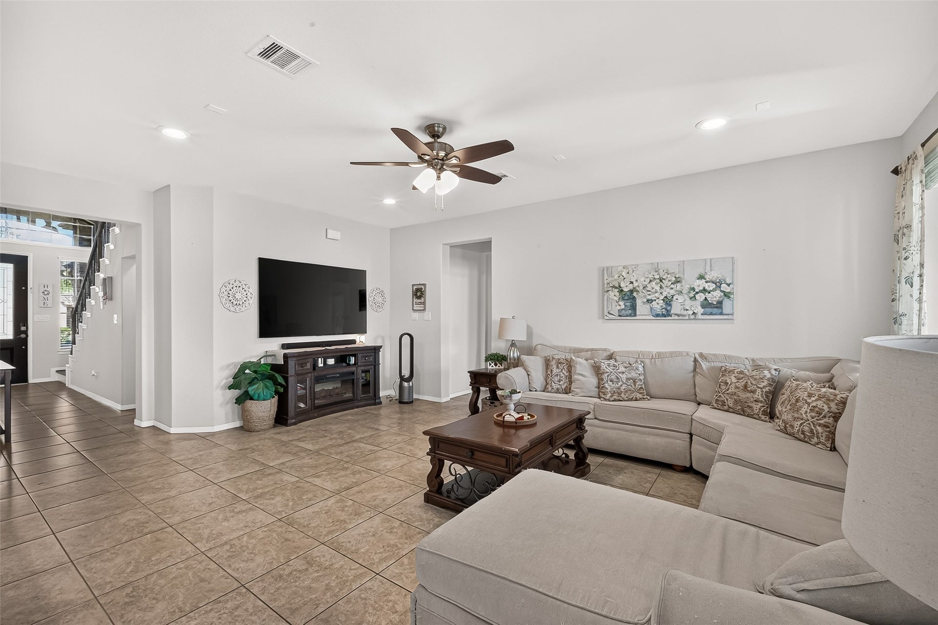 6111 Wayne Way, Rosenberg, TX 77471 The spacious living room offers tile flooring, a ceiling fan, and room to relax.