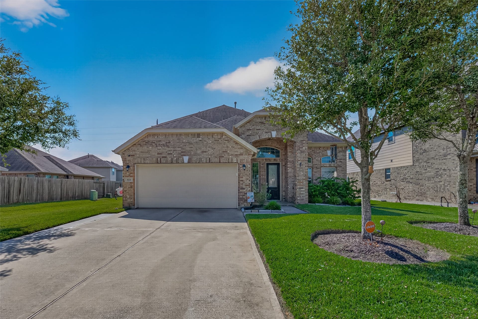 6111 Wayne Way, Rosenberg, TX 77471 A wide driveway and attached garage complement the landscaped front yard at this Kingdom Heights home.