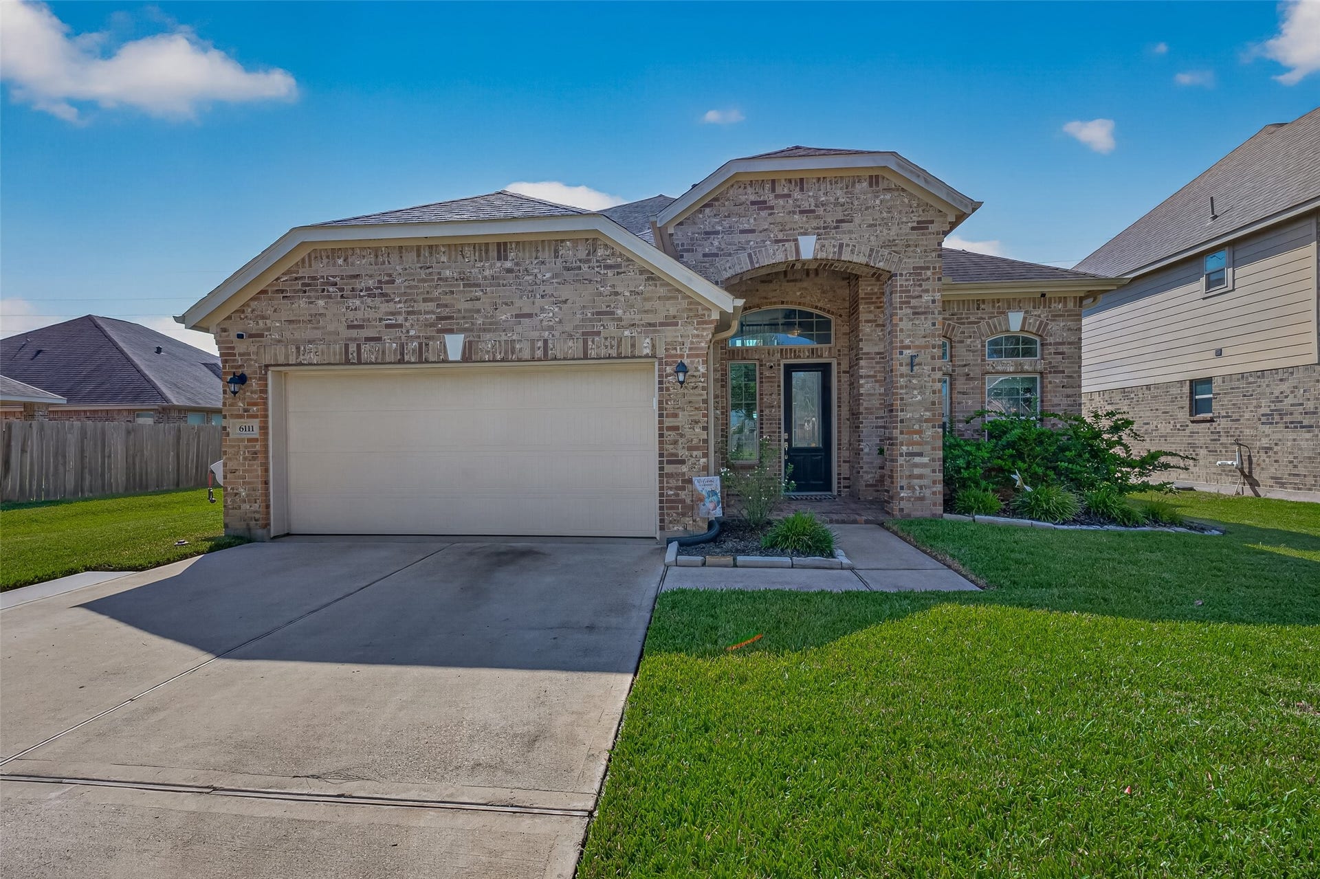 6111 Wayne Way, Rosenberg, TX 77471 Welcome to 6111 Wayne Way in Kingdom Heights, Rosenberg, TX, featuring a brick exterior and inviting covered entry.