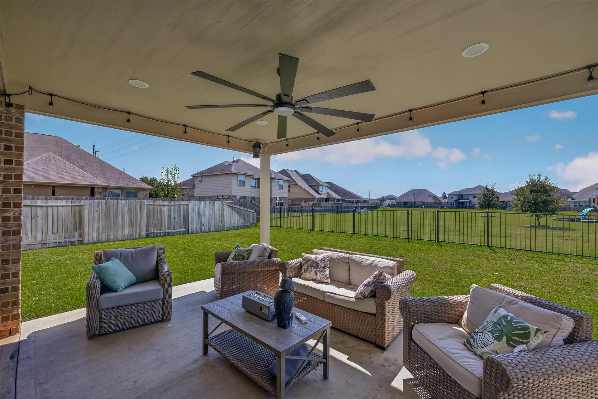 6111 Wayne Way, Rosenberg, TX 77471 The covered outdoor seating area offers a comfortable setting for conversation or a quiet evening.
