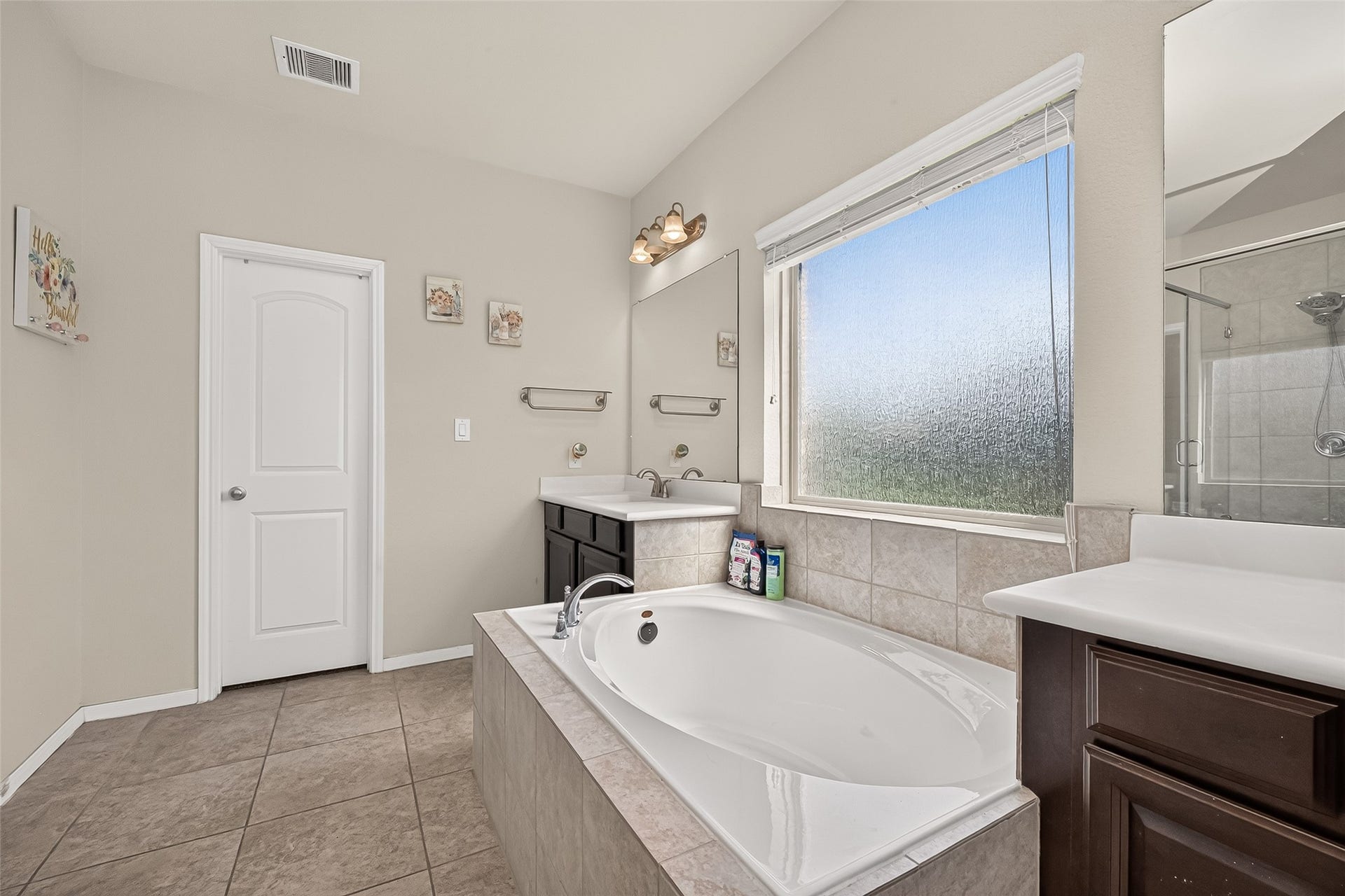 6111 Wayne Way, Rosenberg, TX 77471 Natural light, tile flooring, and dark cabinetry complete the primary bathroom.