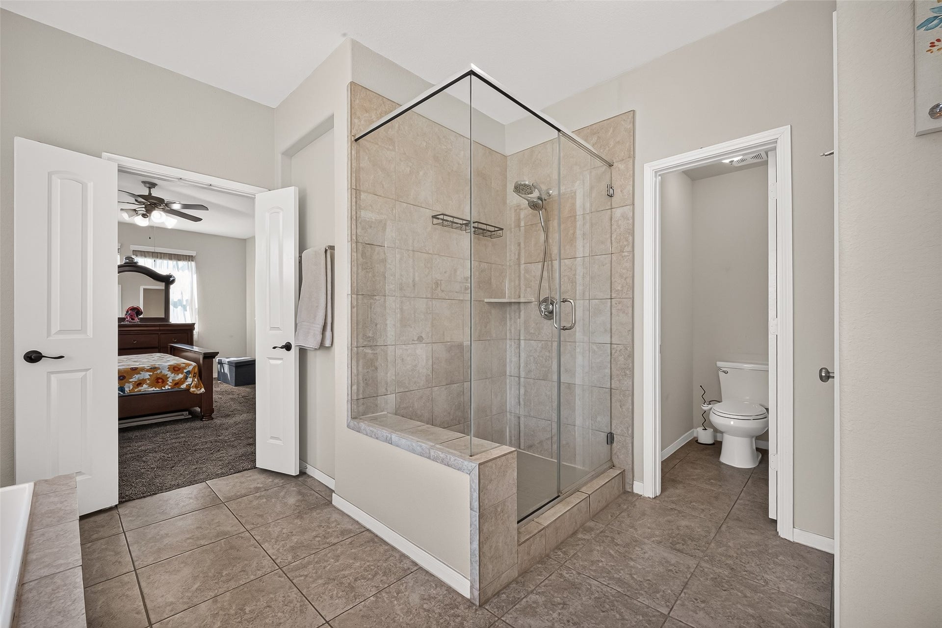 6111 Wayne Way, Rosenberg, TX 77471 A closer look at the primary bathroom's walk-in shower and connection to the bedroom.