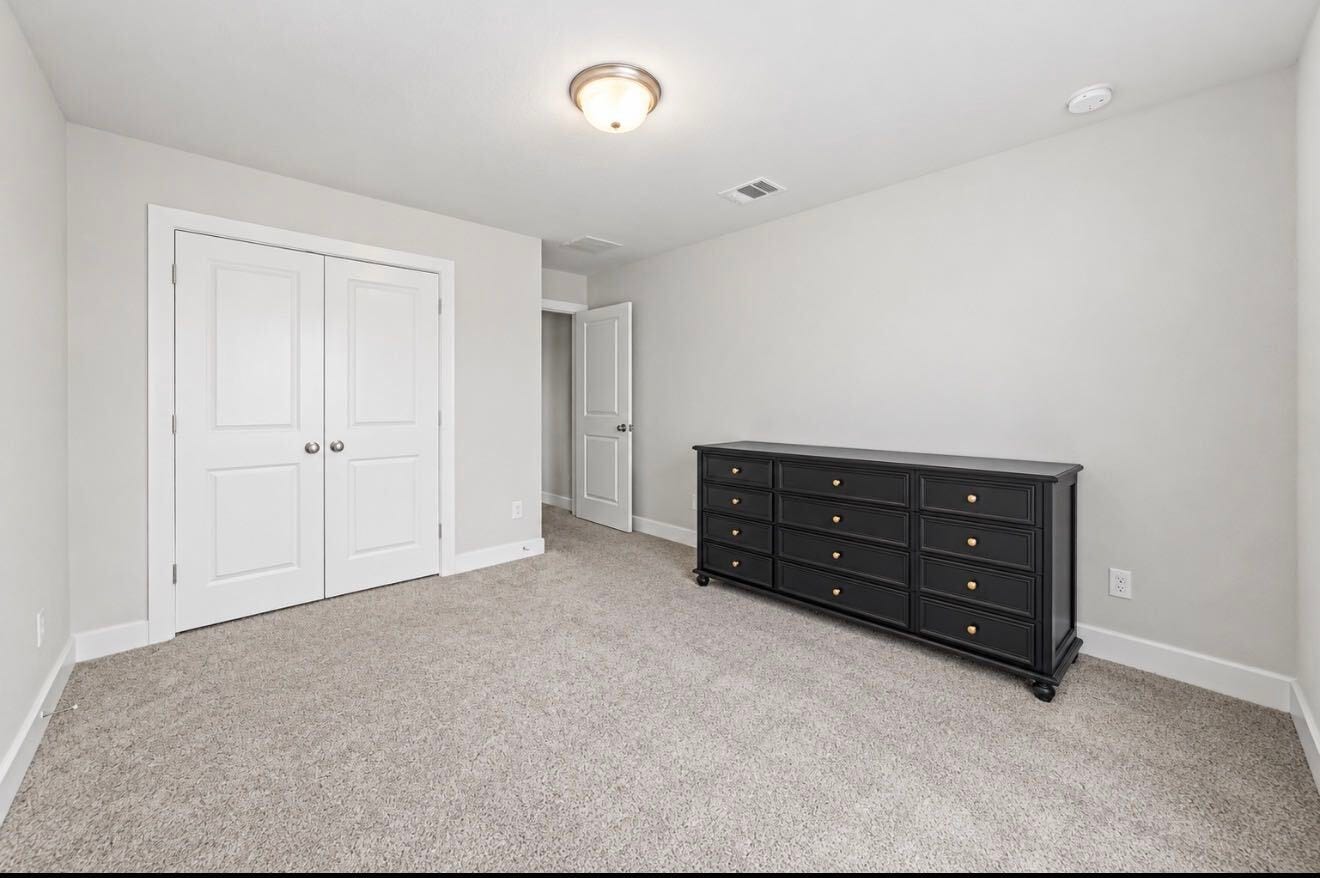 9231 Dearborn Knoll Drive, Cypress, TX 77433 One of three secondary bedrooms upstairs, this room offers plush carpet and a double-door closet.