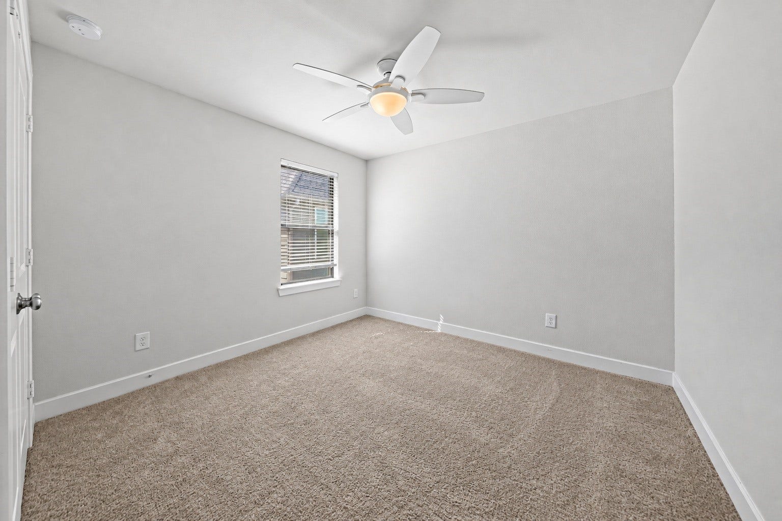 9231 Dearborn Knoll Drive, Cypress, TX 77433 Another upstairs bedroom with soft carpet, a ceiling fan and a window that brings in natural light, ready for guests, family, or a hobby space.