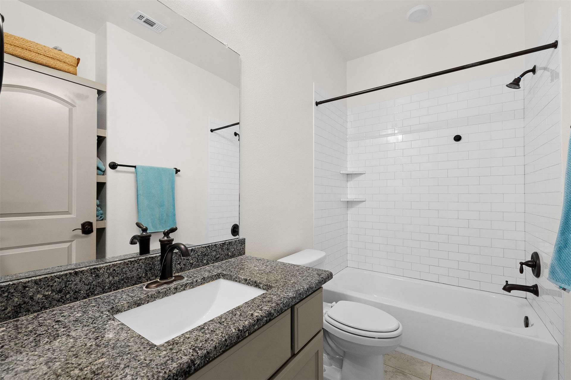 8603 Woods Hollow Trail, Fulshear, TX 77406 Ensuite bath has a tub/shower combo and additional shelf storage.