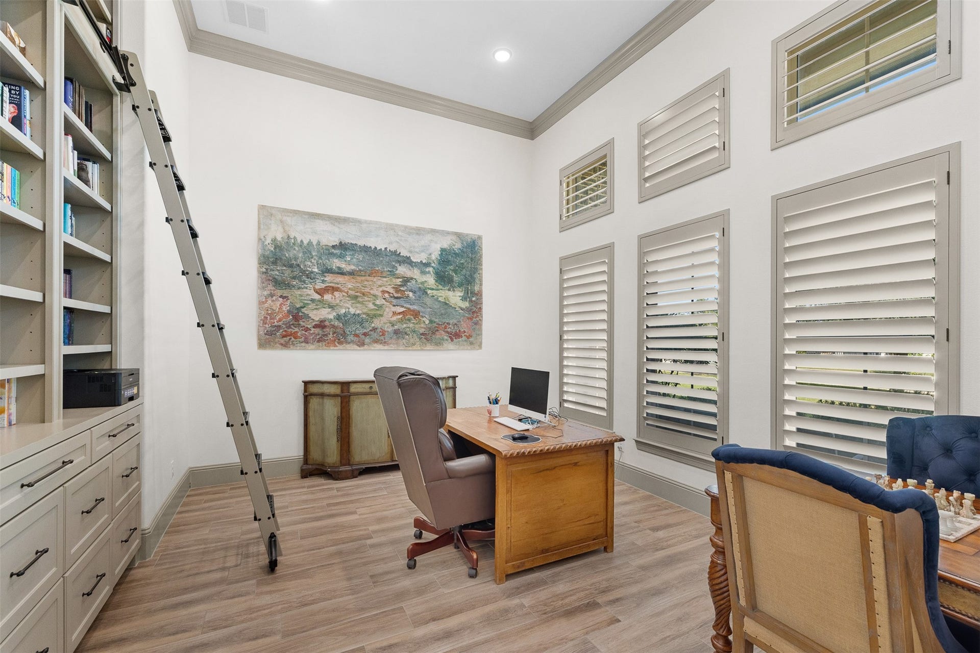 8603 Woods Hollow Trail, Fulshear, TX 77406 At the front of the home off the entry is the study. A built in bookcase meets the soaring 14ft ceiling. Includes a sliding ladder and file or art storage.