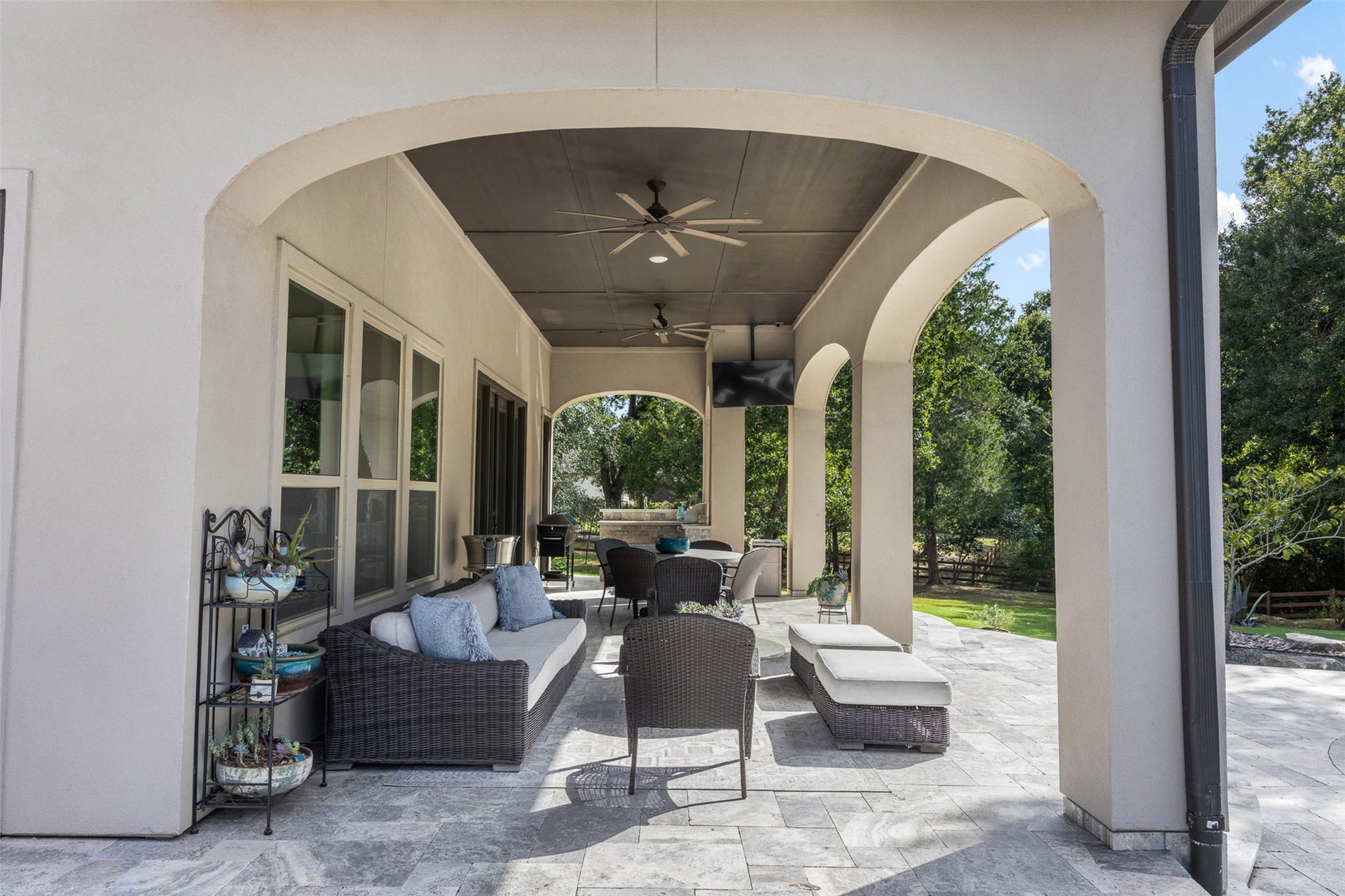 8603 Woods Hollow Trail, Fulshear, TX 77406 Covered patio off the gameroom includes an outdoor kitchen with grill and sink.