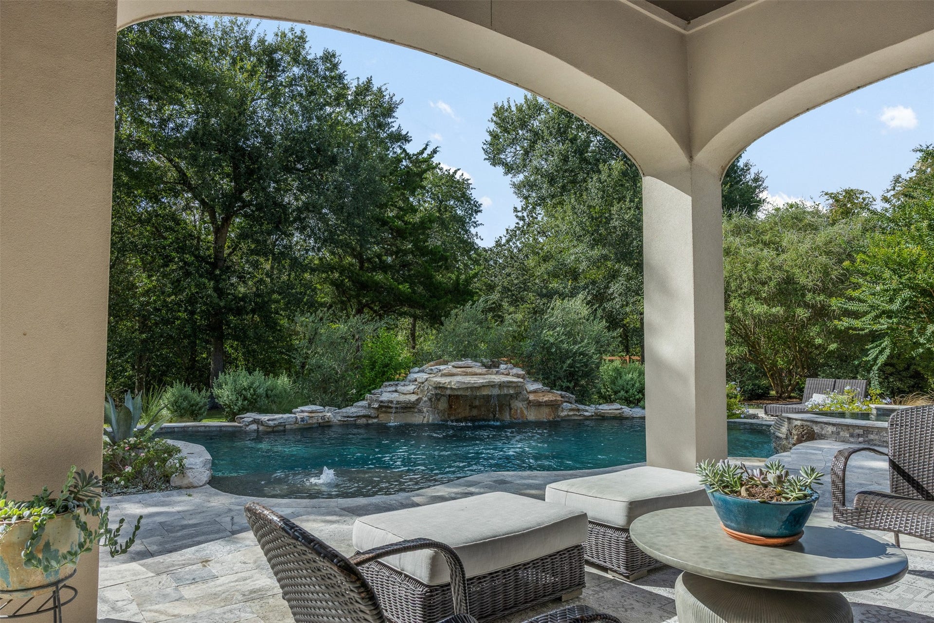 8603 Woods Hollow Trail, Fulshear, TX 77406 Hill country rocks were used to create a cave that doubles as a jumping spot into the deepest part of the pool.