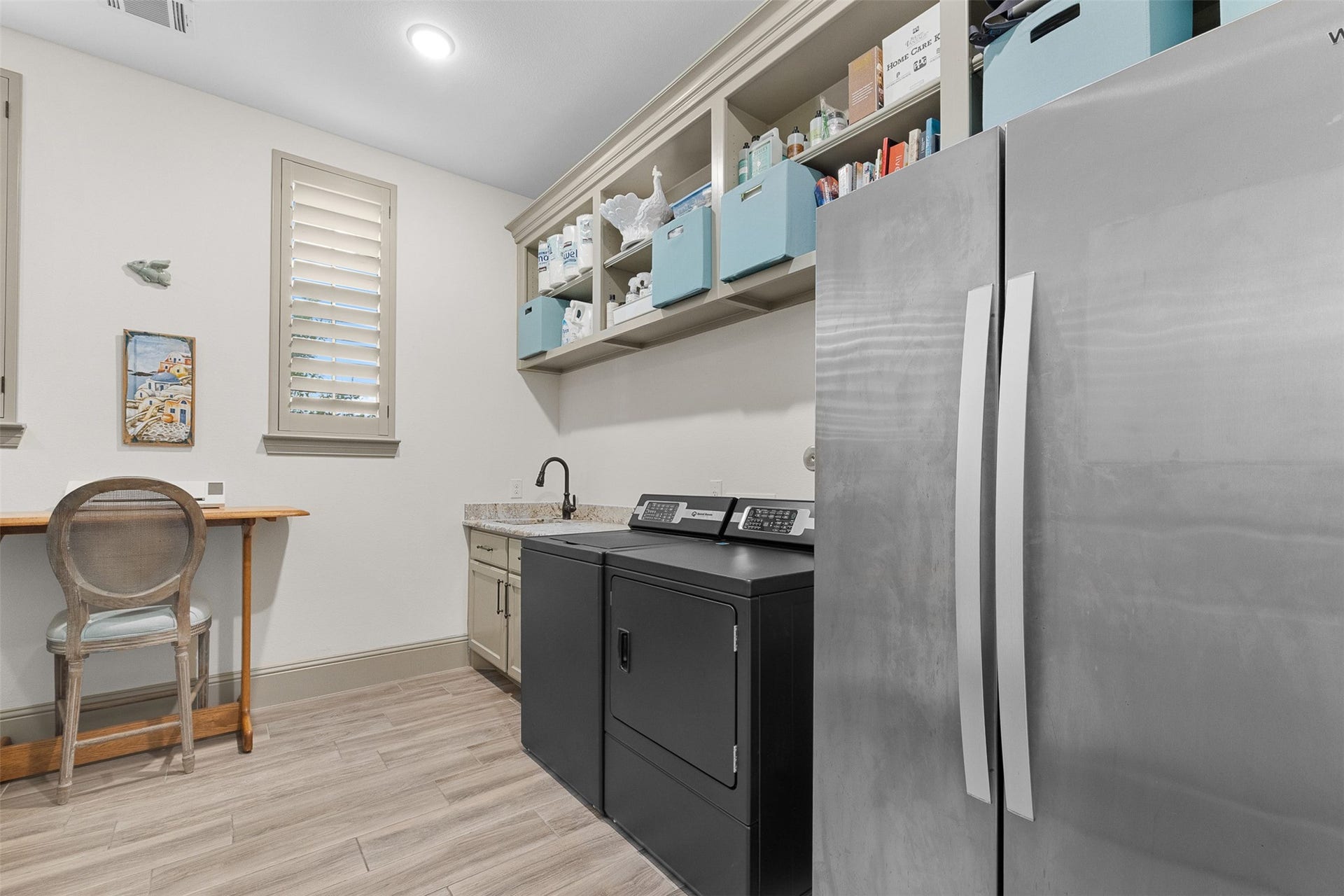 8603 Woods Hollow Trail, Fulshear, TX 77406 Laundry room off the main hallway has a sink, room for a fridge, and storage abounds.