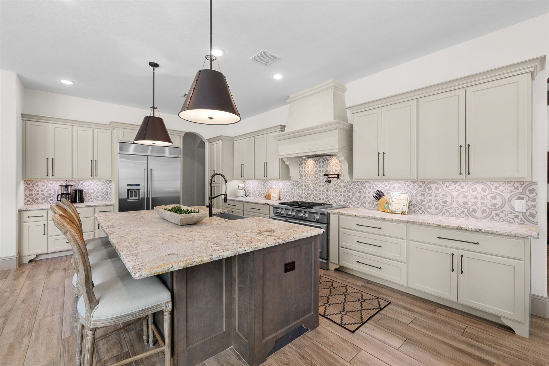 8603 Woods Hollow Trail, Fulshear, TX 77406 Built in commercial grade 48" refrigerator and 6 burner gas range with griddle and double oven. Blanco farmhouse sink.