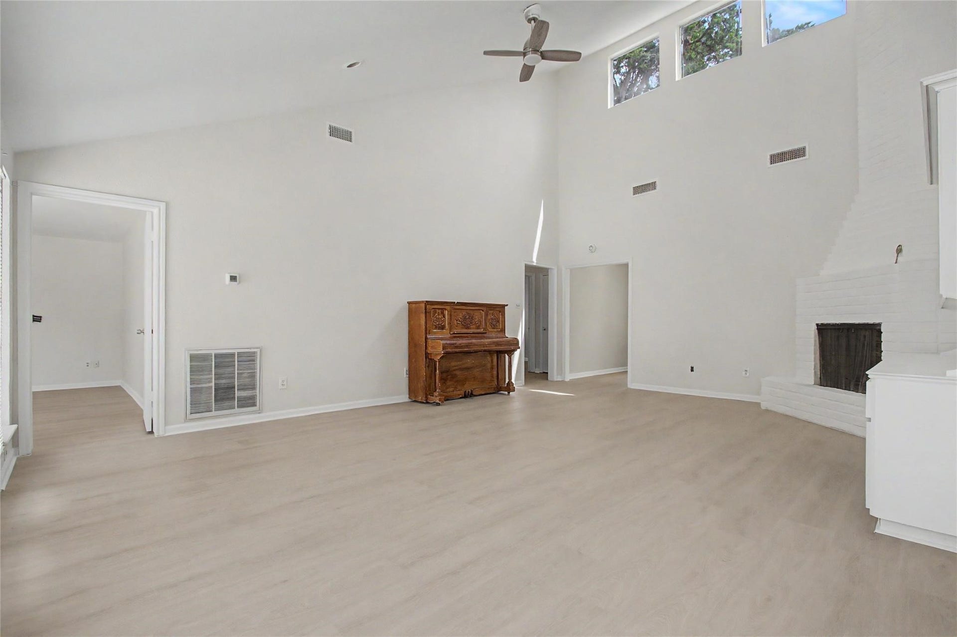 414 N Pecan Dr, Tomball, TX 77375 Formal living room featuring new luxury vinyl plank flooring, fresh paint, a gas fireplace, and built-in bookshelves