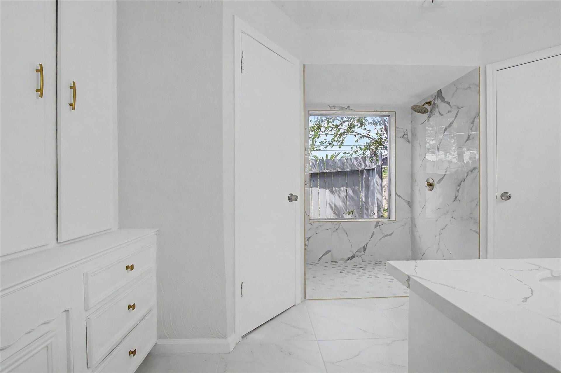 414 N Pecan Dr, Tomball, TX 77375 Primary bathroom featuring new tile flooring, fresh paint, updated finishes, and abundant natural light