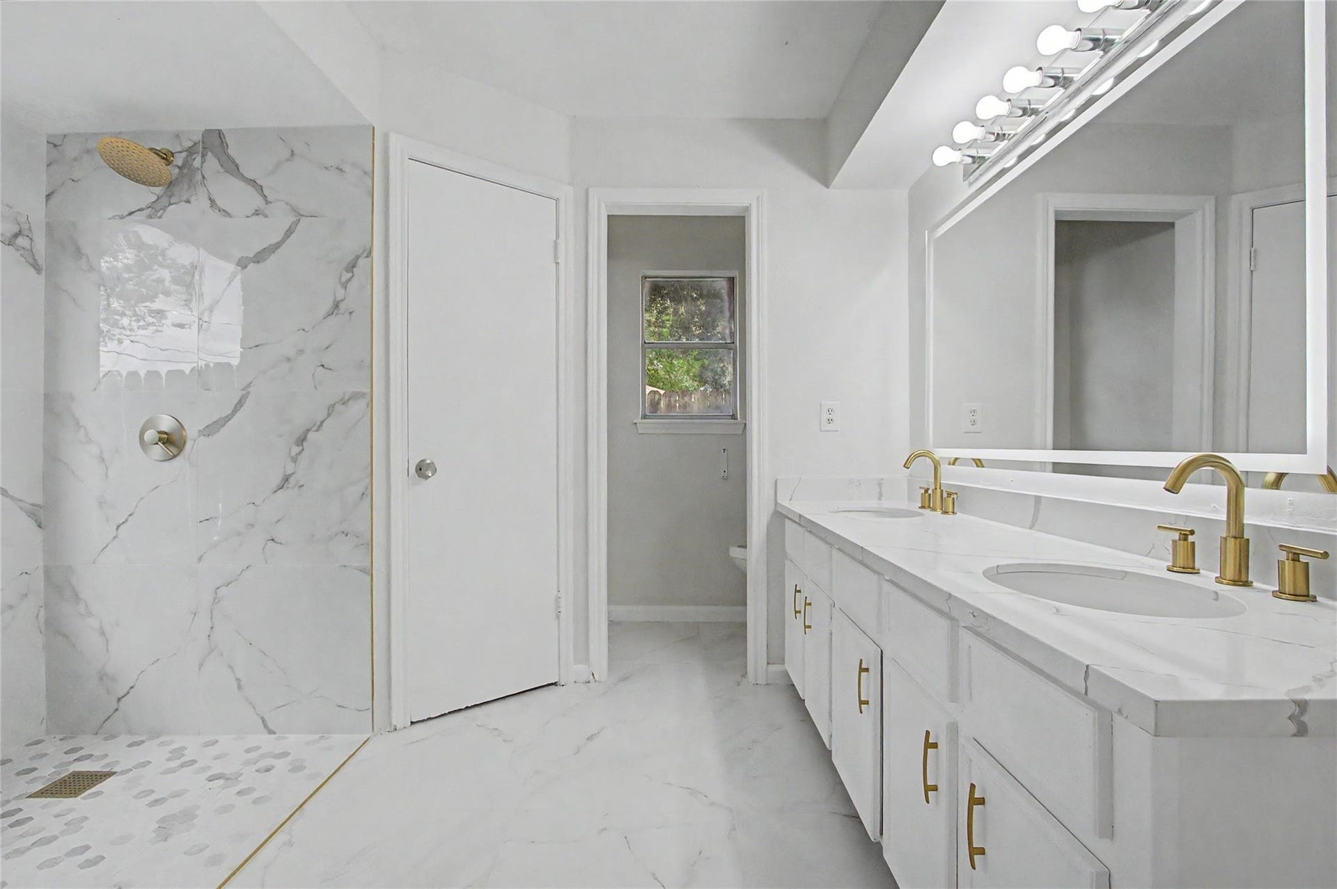 414 N Pecan Dr, Tomball, TX 77375 Primary bathroom featuring new tile flooring, fresh paint, updated finishes, and abundant natural light