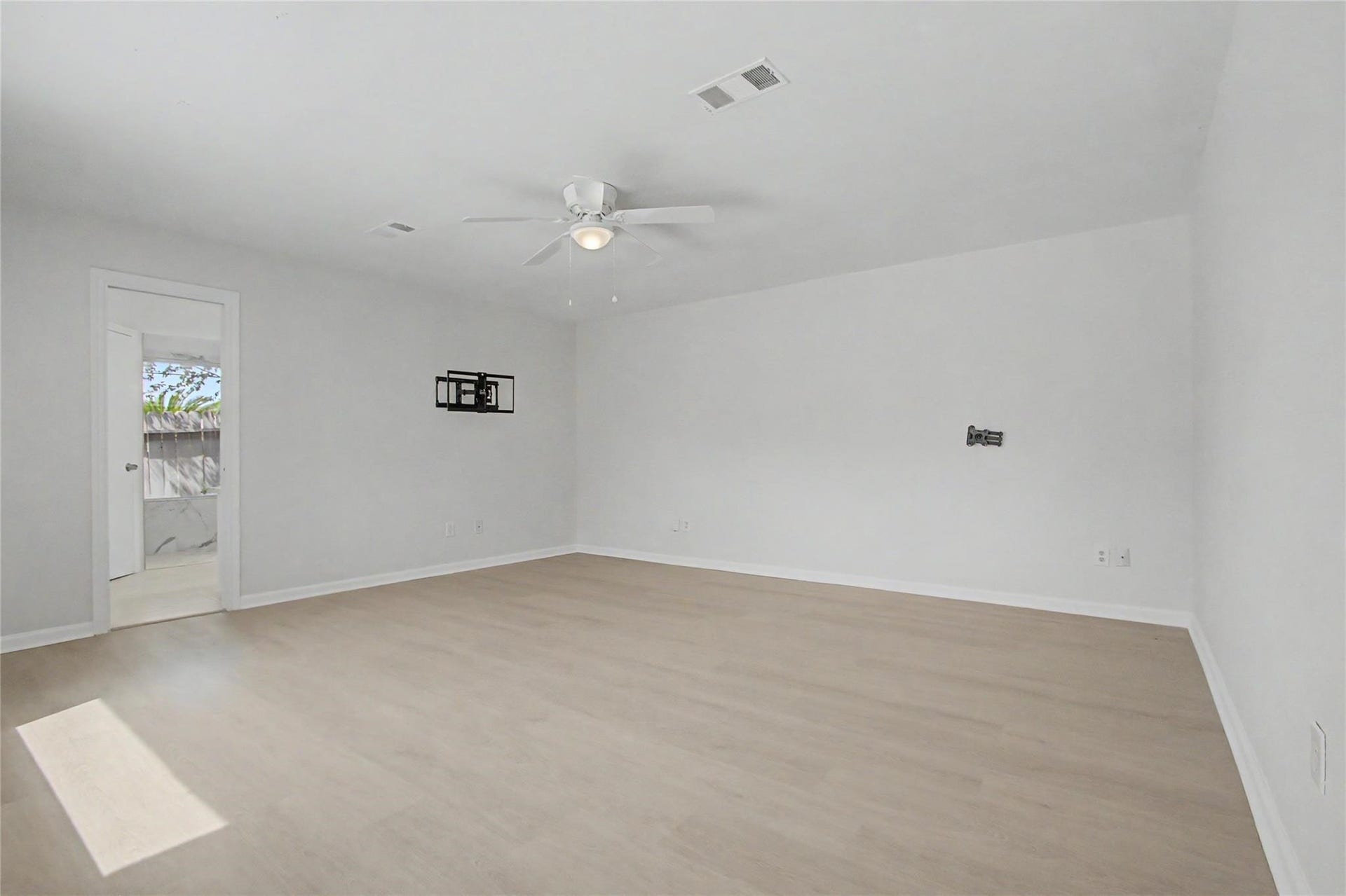 414 N Pecan Dr, Tomball, TX 77375 Primary bedroom featuring fresh paint, new luxury vinyl plank flooring, and abundant natural light.