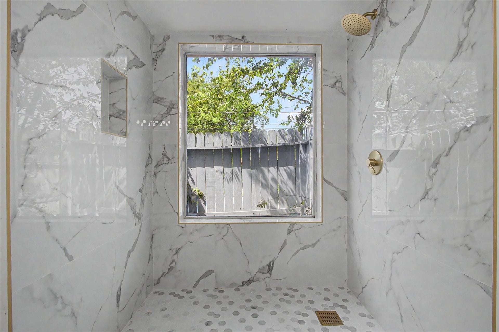 414 N Pecan Dr, Tomball, TX 77375 Primary bathroom featuring new tile flooring, fresh paint, updated finishes, and abundant natural light