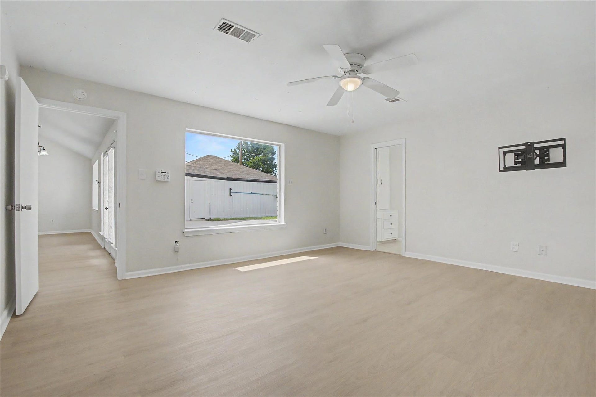 414 N Pecan Dr, Tomball, TX 77375 Primary bedroom featuring fresh paint, new luxury vinyl plank flooring, and abundant natural light.