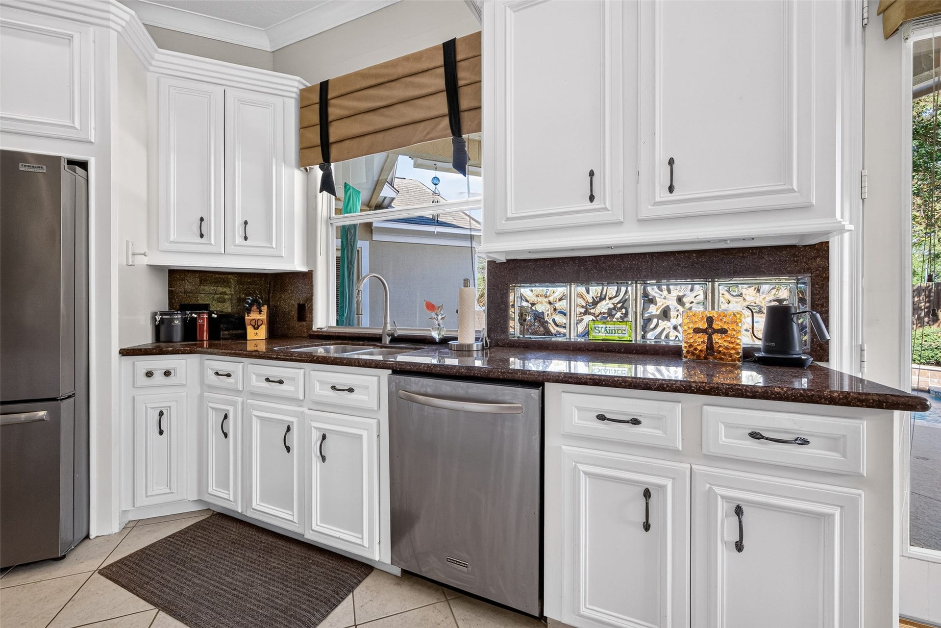 Large kitchen window and additional glass blocks add to the charm of this kitchen design.