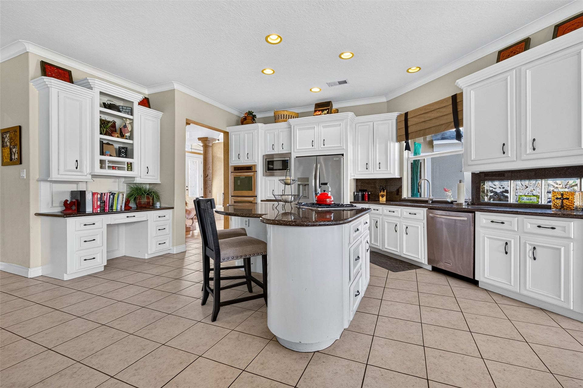 Look at this wonderful kitchen!  It features granite counter tops, a fabulous island w/ cooktop, stainless appliances, a double oven and an abundance of storage and cabinet space.